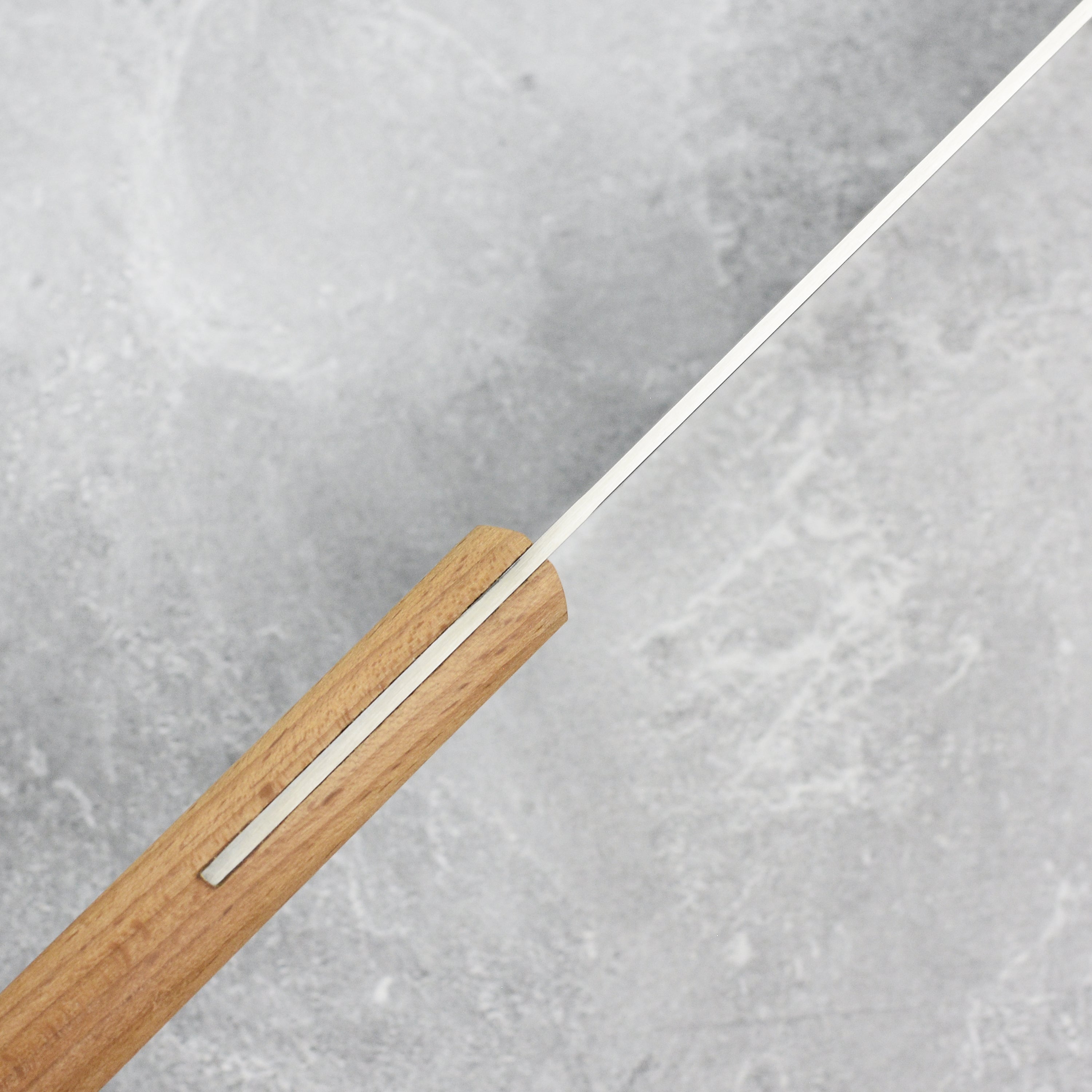 Detailed view of the ergonomic handle and sharp edge of the kitchen knife