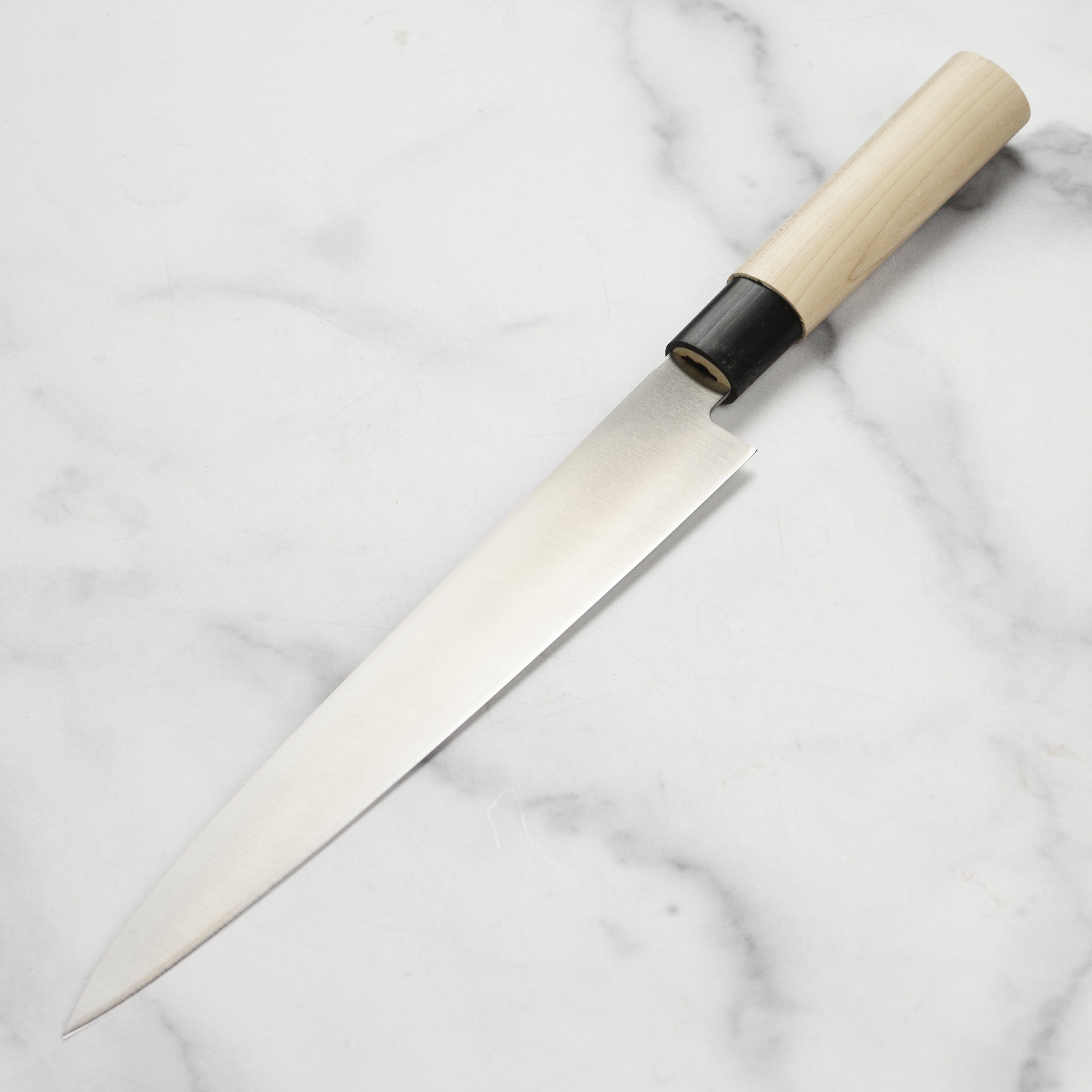Close-up of the Tojiro MV Yanagiba Knife highlighting the beautiful magnolia wood handle.