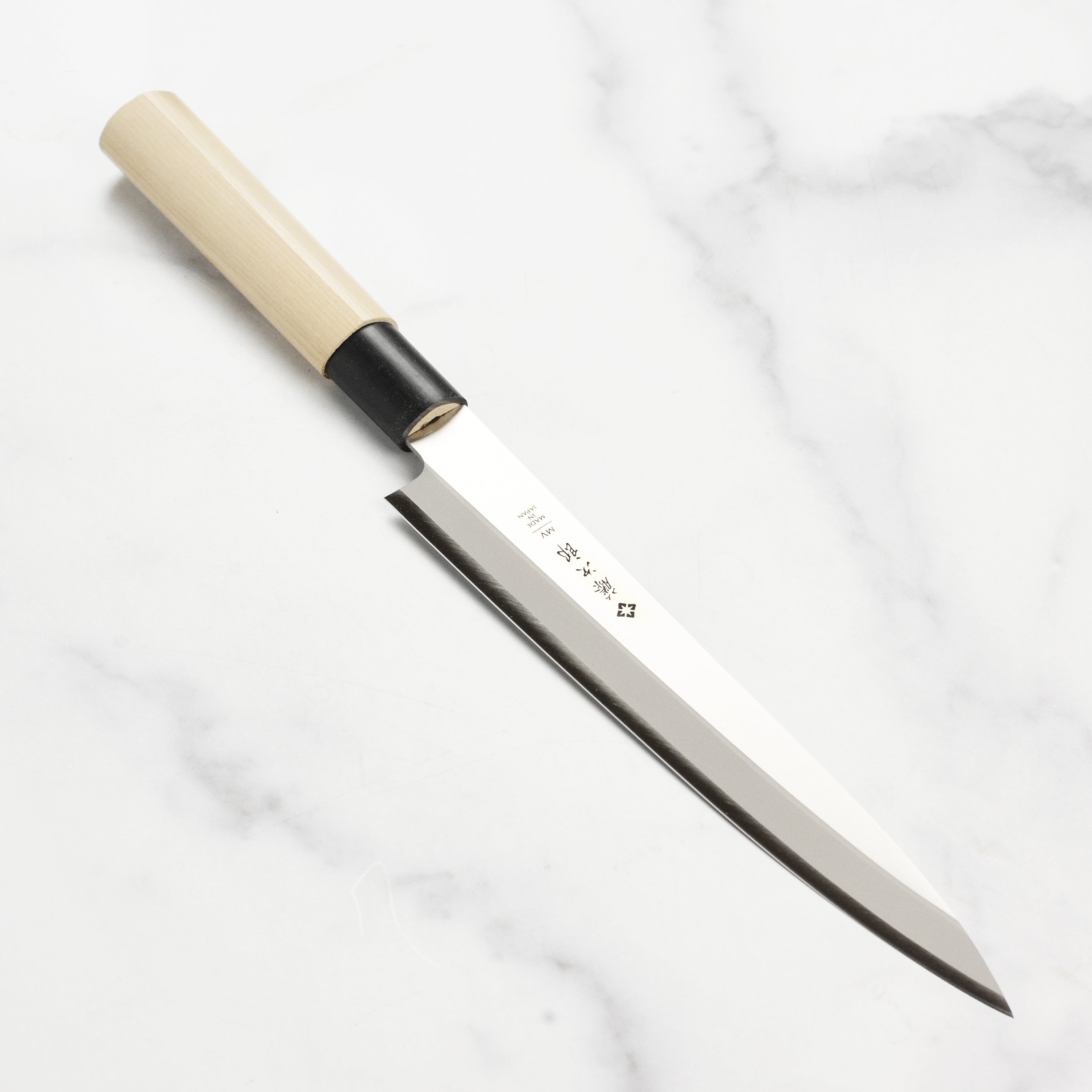 Tojiro MV 8.25 inch yanagiba sushi knife showcasing its sharp blade and ergonomic handle.