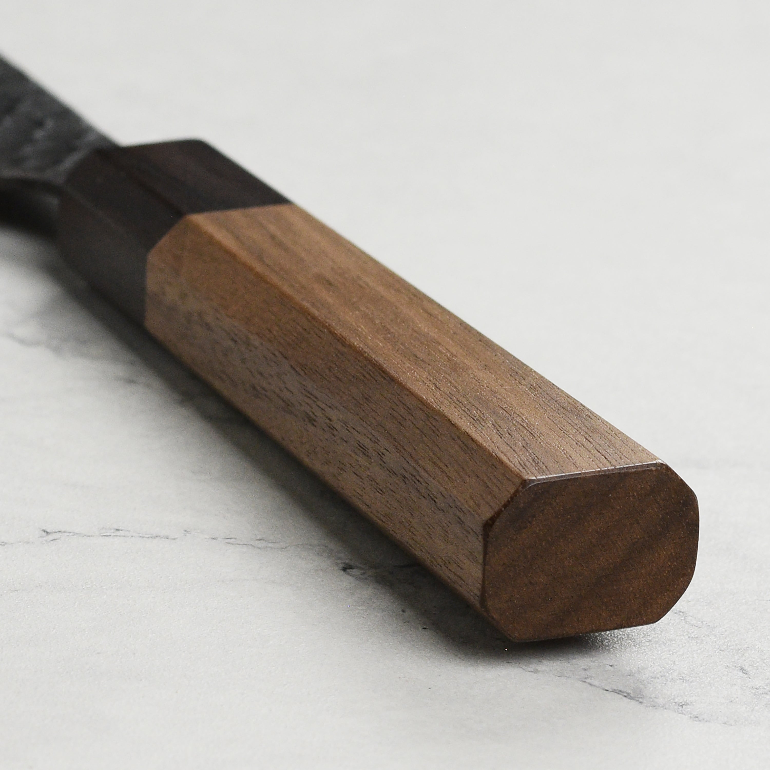 Usage shot of the Japanese kiritsuke knife slicing vegetables on a cutting board