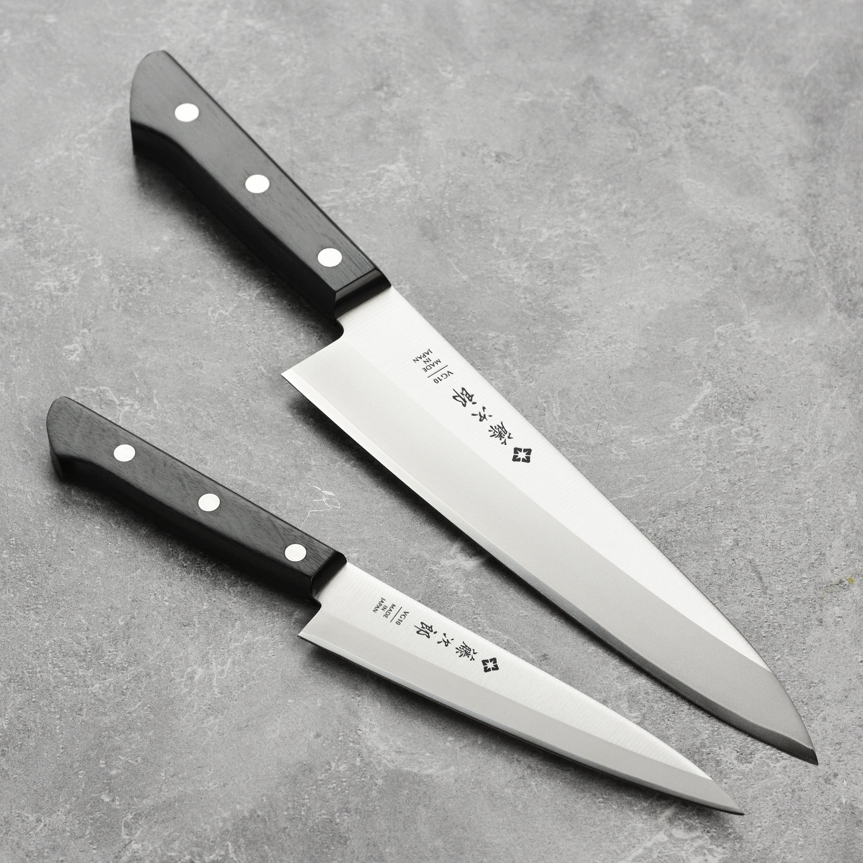 Close-up of the Tojiro Japanese chef knife highlighting the sharp blade and Pakkawood handle.