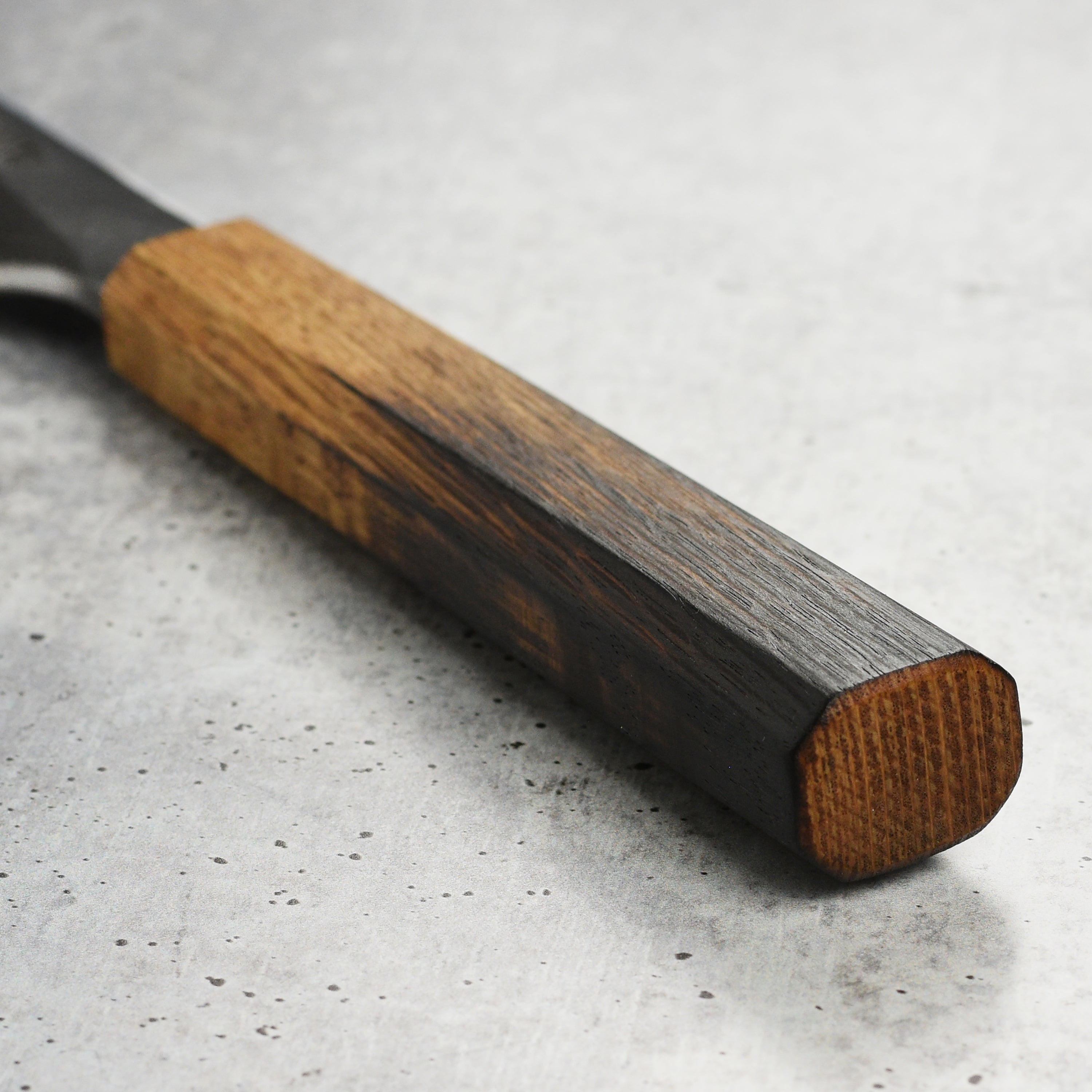 Side view of the Takayuki Yanagiba knife, highlighting the ergonomic handle and single bevel edge.