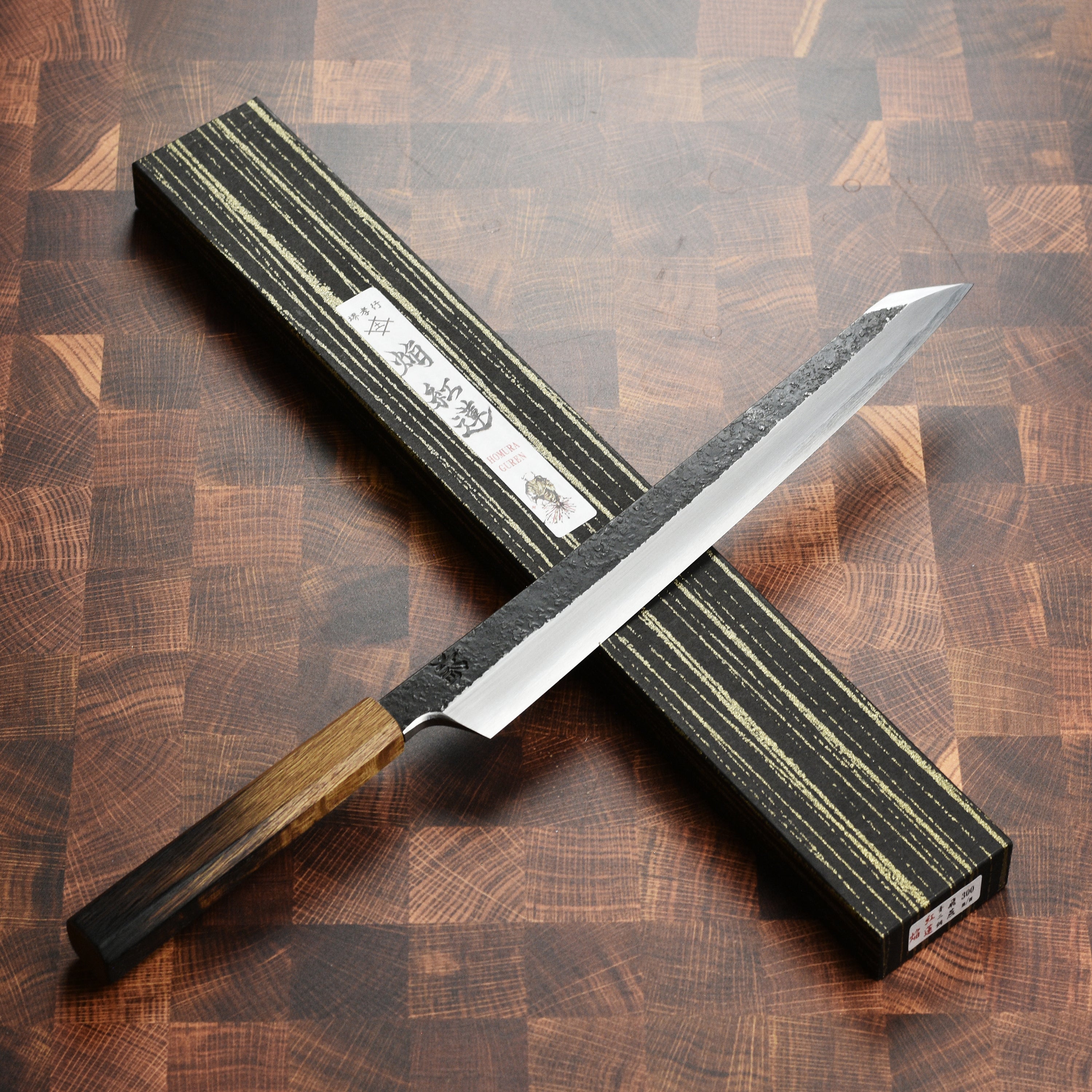 Action shot of the Takayuki Yanagiba knife slicing through sushi, demonstrating its precision and ease of use.