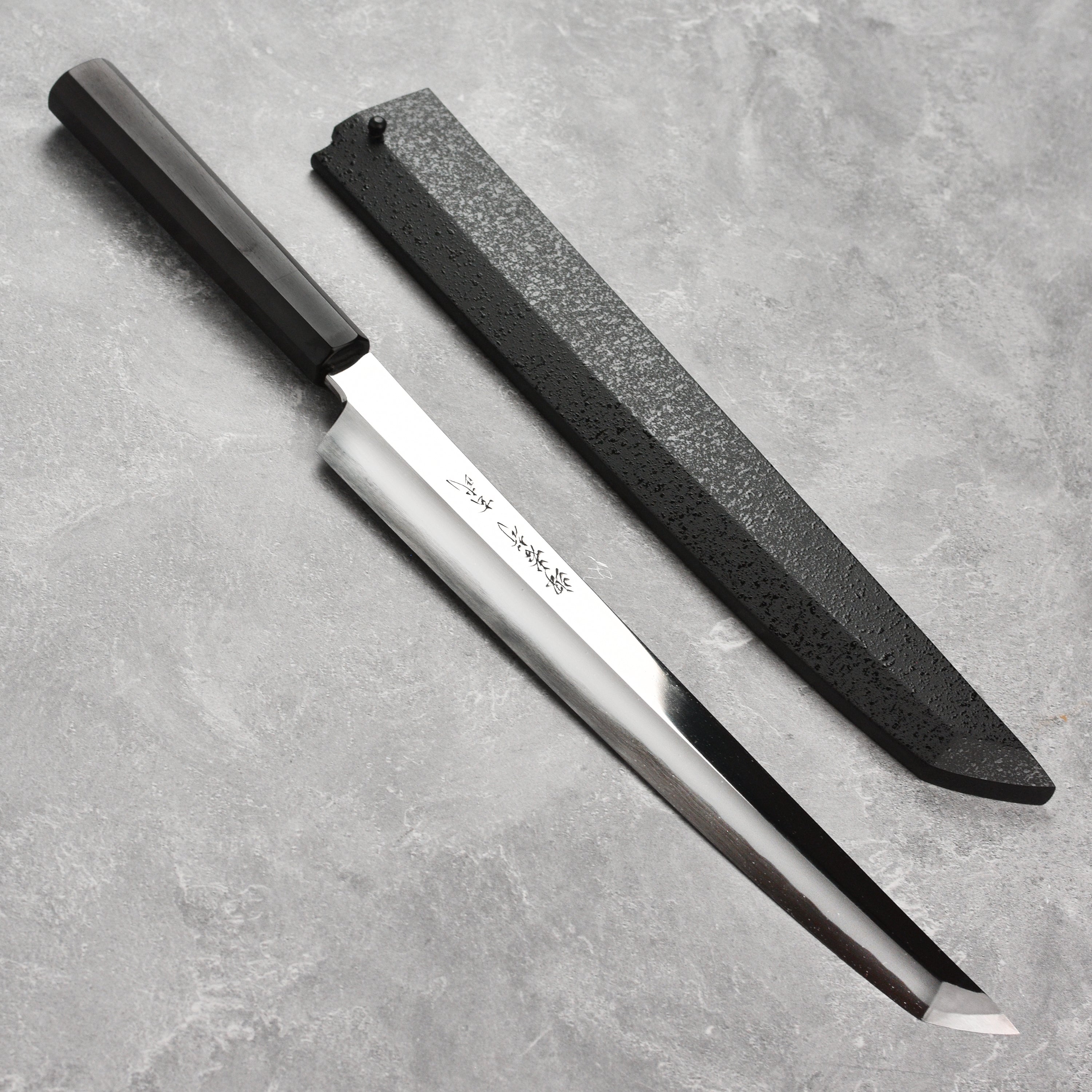 Close-up of Aogami Yanagiba knife showcasing its sharp edge and craftsmanship.