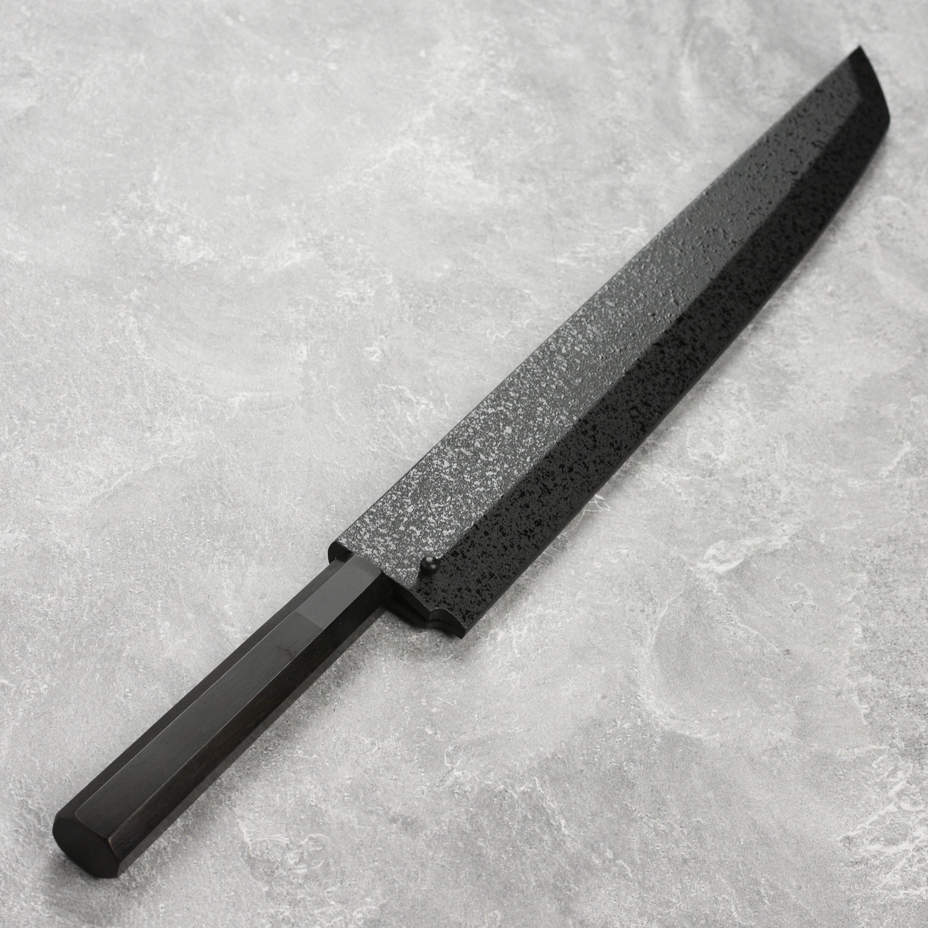 Yanagiba knife in use, expertly slicing sushi rolls on a wooden cutting board.