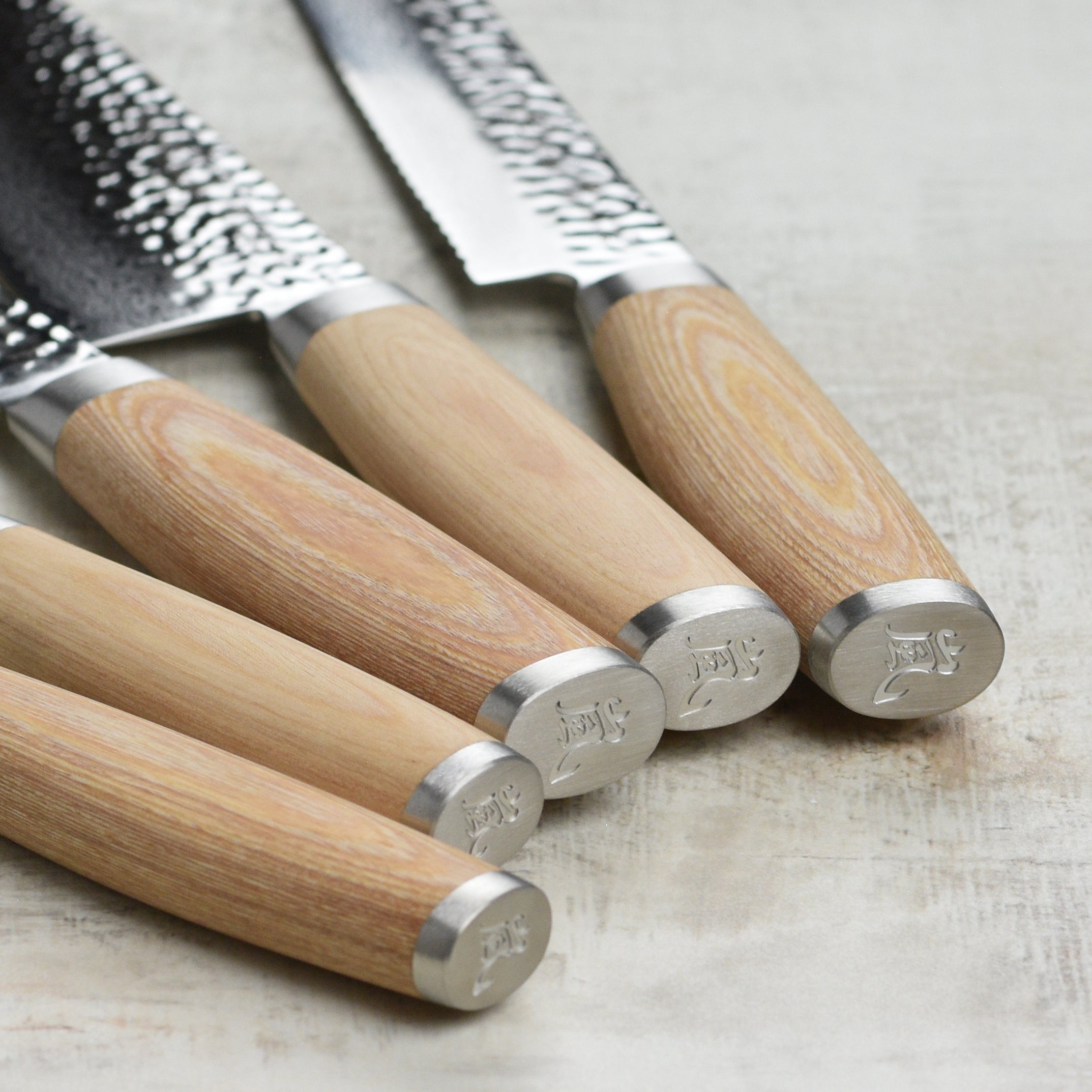 Close-up of VG-10 steel blade edge showing double bevel and Damascus layering