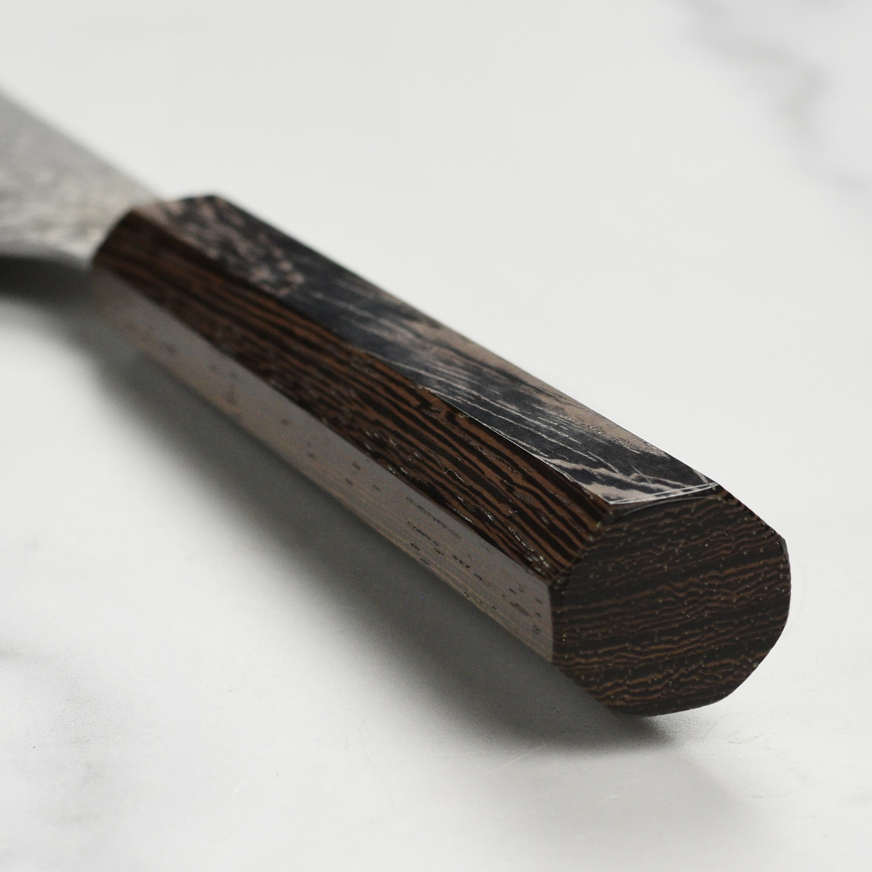Chef using Takayuki 5.3 inch Japanese Damascus knife in a professional kitchen