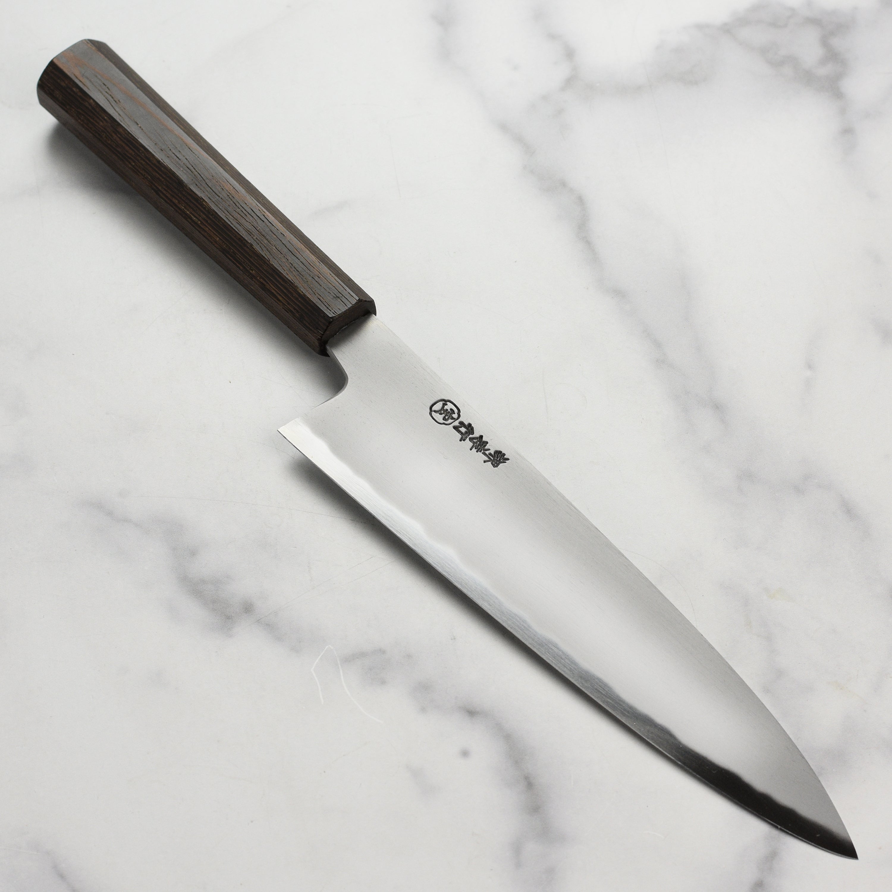 Takayuki Sanpou Japanese Gyuto knife with a focus on the hand-forged blade and sharp edge
