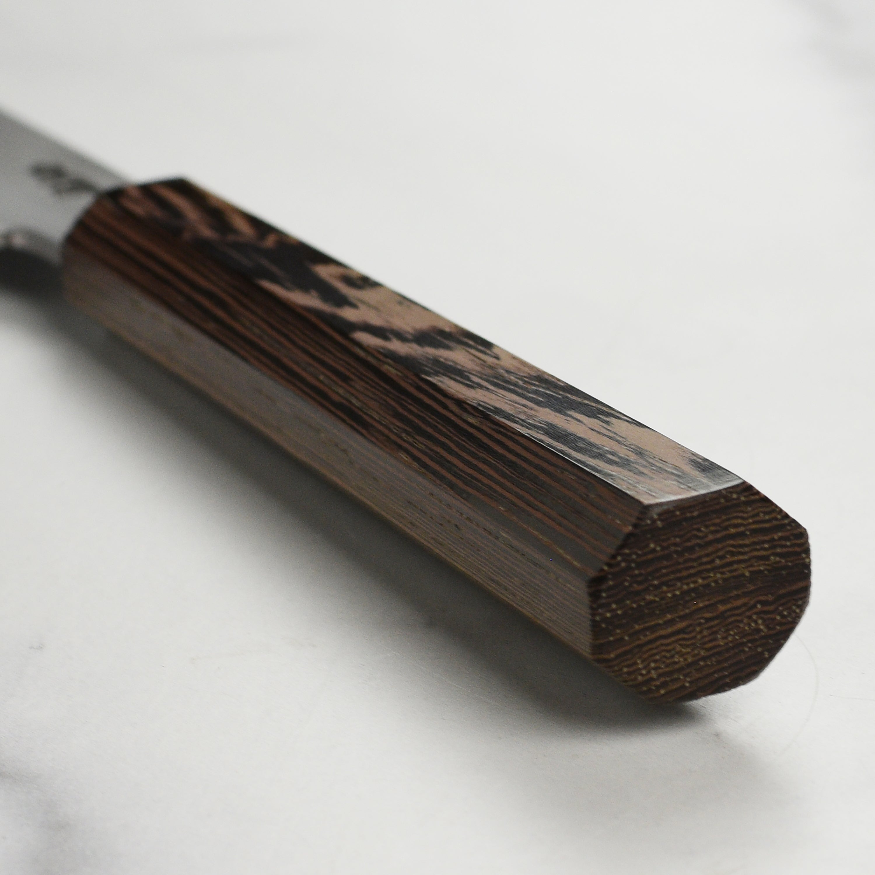 Close-up of the Takayuki Shirogami petty knife highlighting its sharp blade and ergonomic handle.