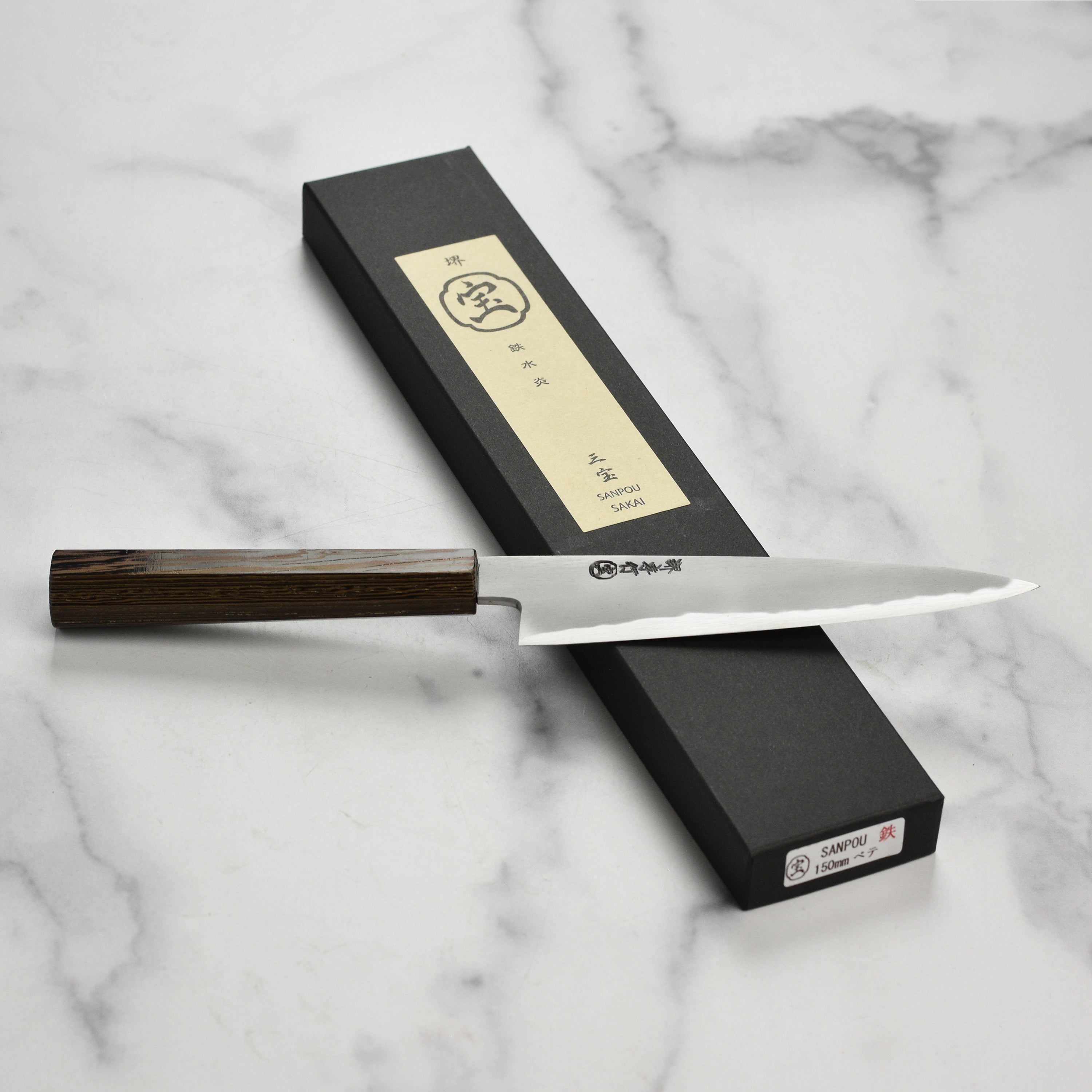 Takayuki Shirogami knife in use, demonstrating its effectiveness for detailed culinary tasks.