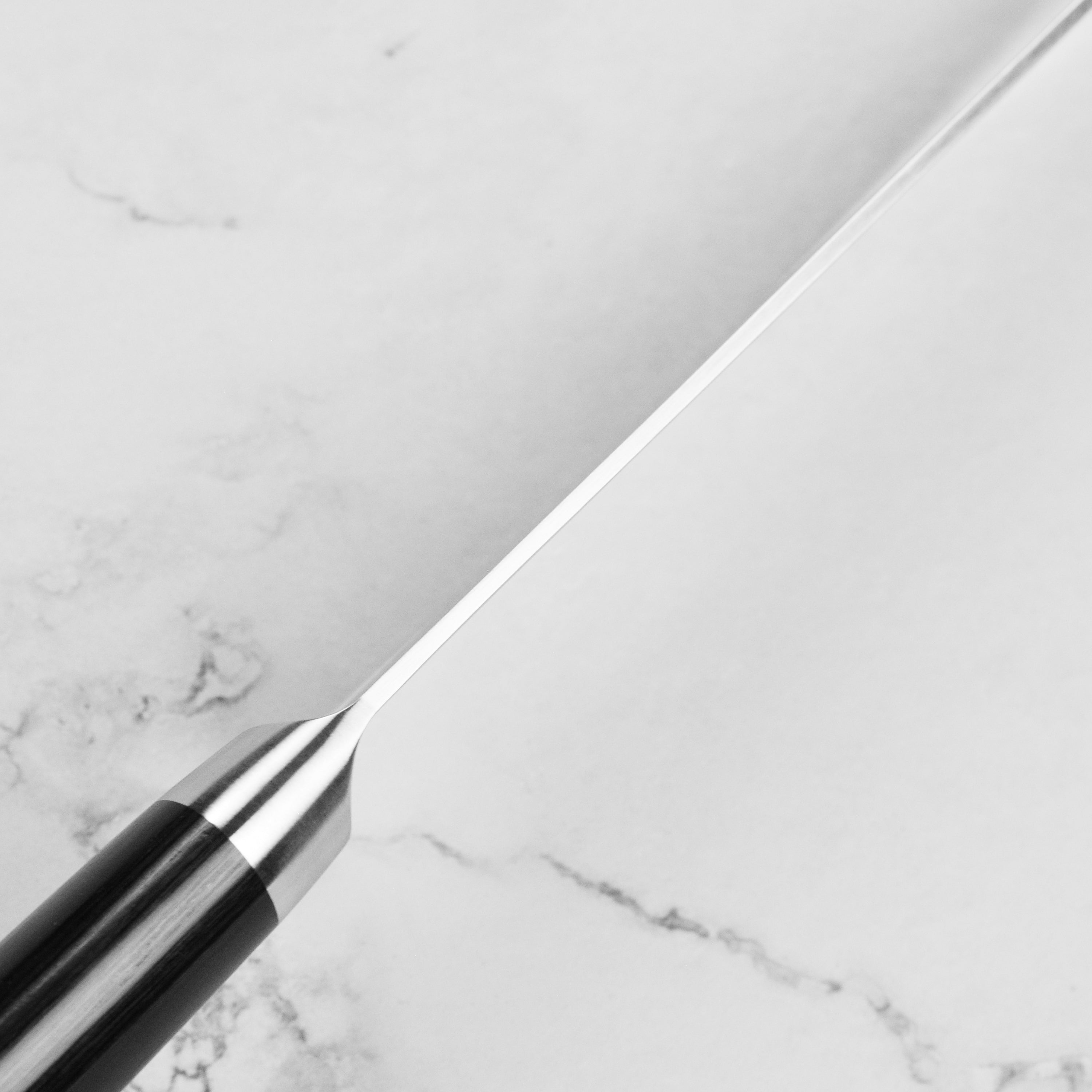 Close-up of the blade of the Premium 6-Inch Handcrafted Japanese Bunka Knife showcasing its Damascus pattern.