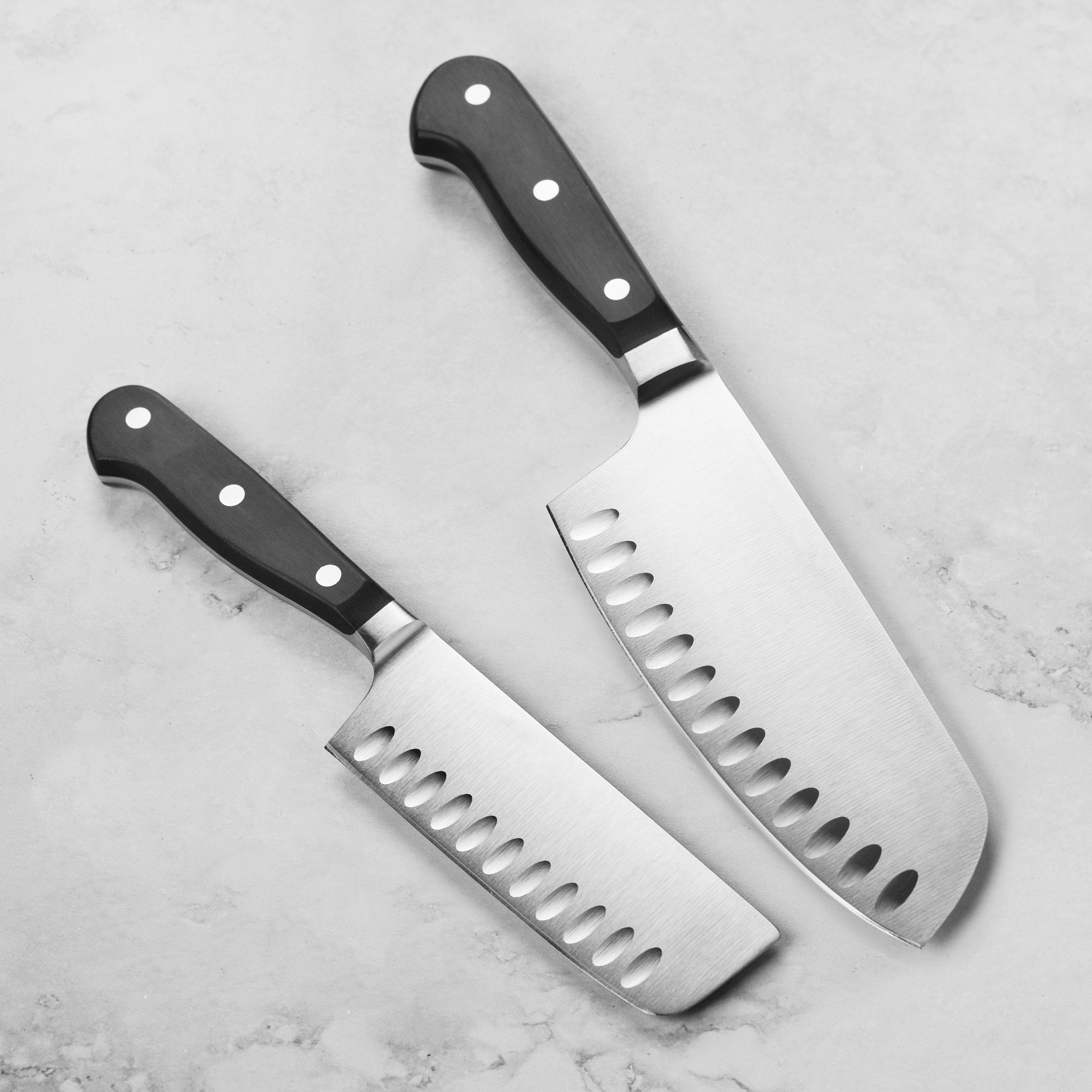 Wusthof Classic knife duo displayed beautifully on a wooden cutting board.