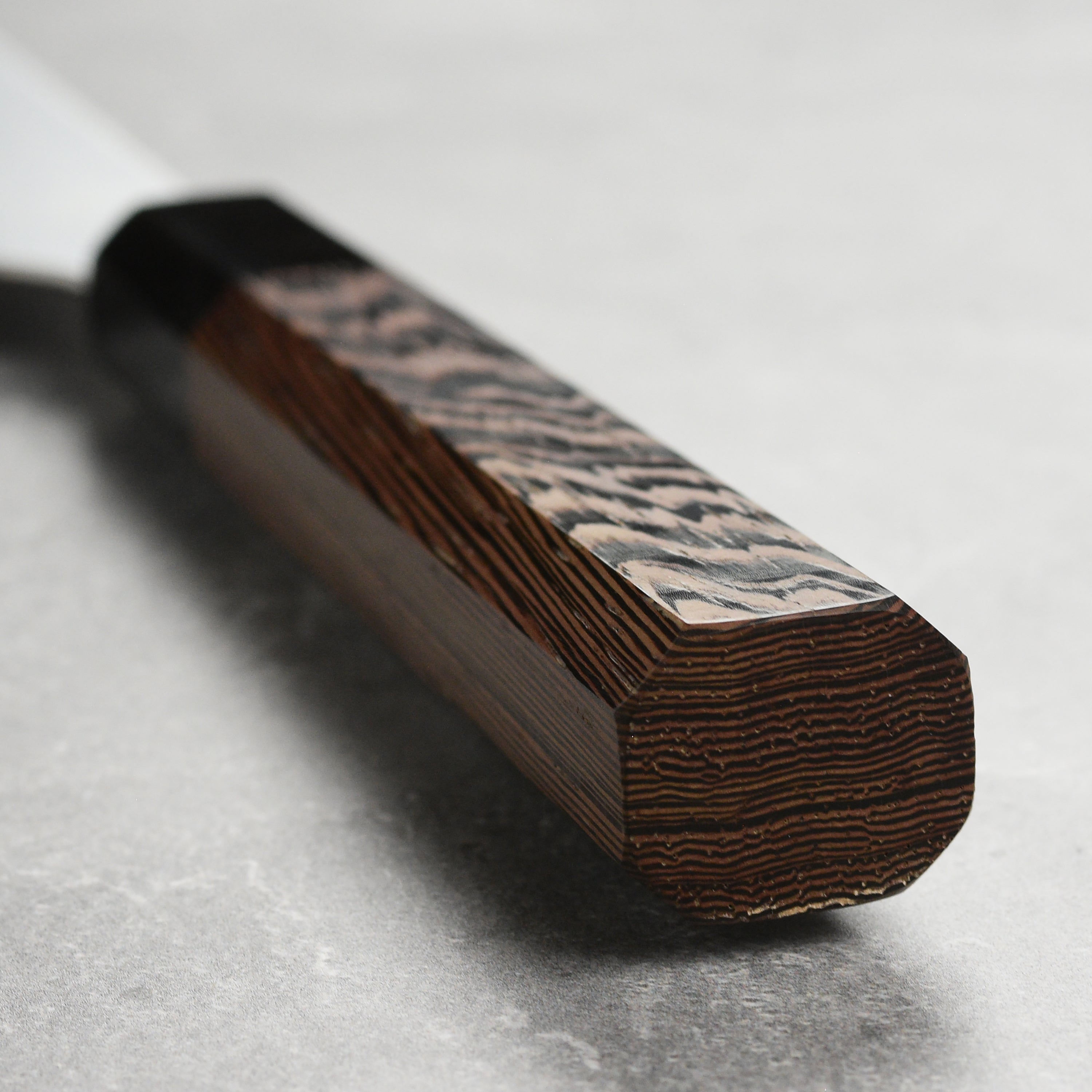 Close-up of the Aogami steel blade of the Hatsukokoro sujihiki knife, highlighting its craftsmanship.