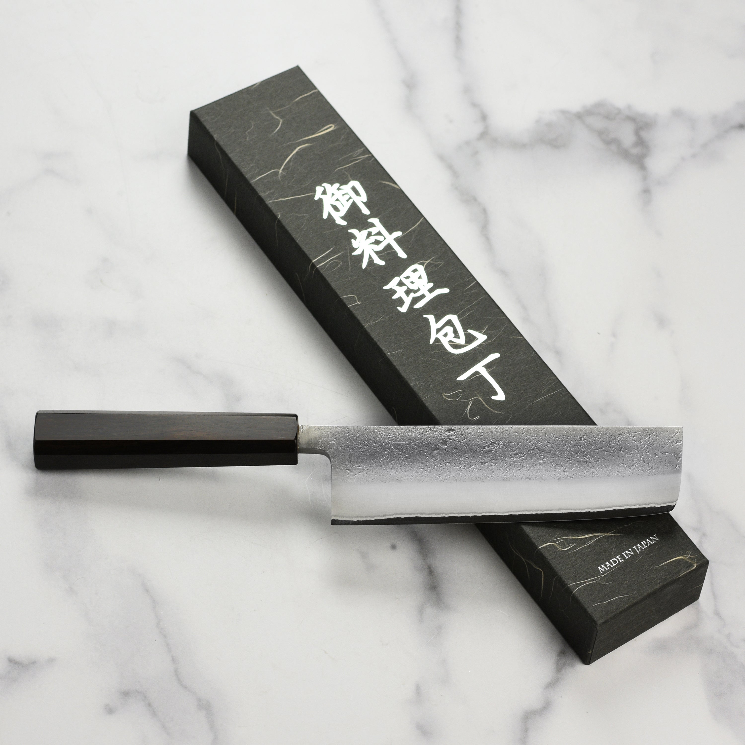 Yoshikane Nakiri Knife in a kitchen setting, demonstrating its use for vegetable chopping.