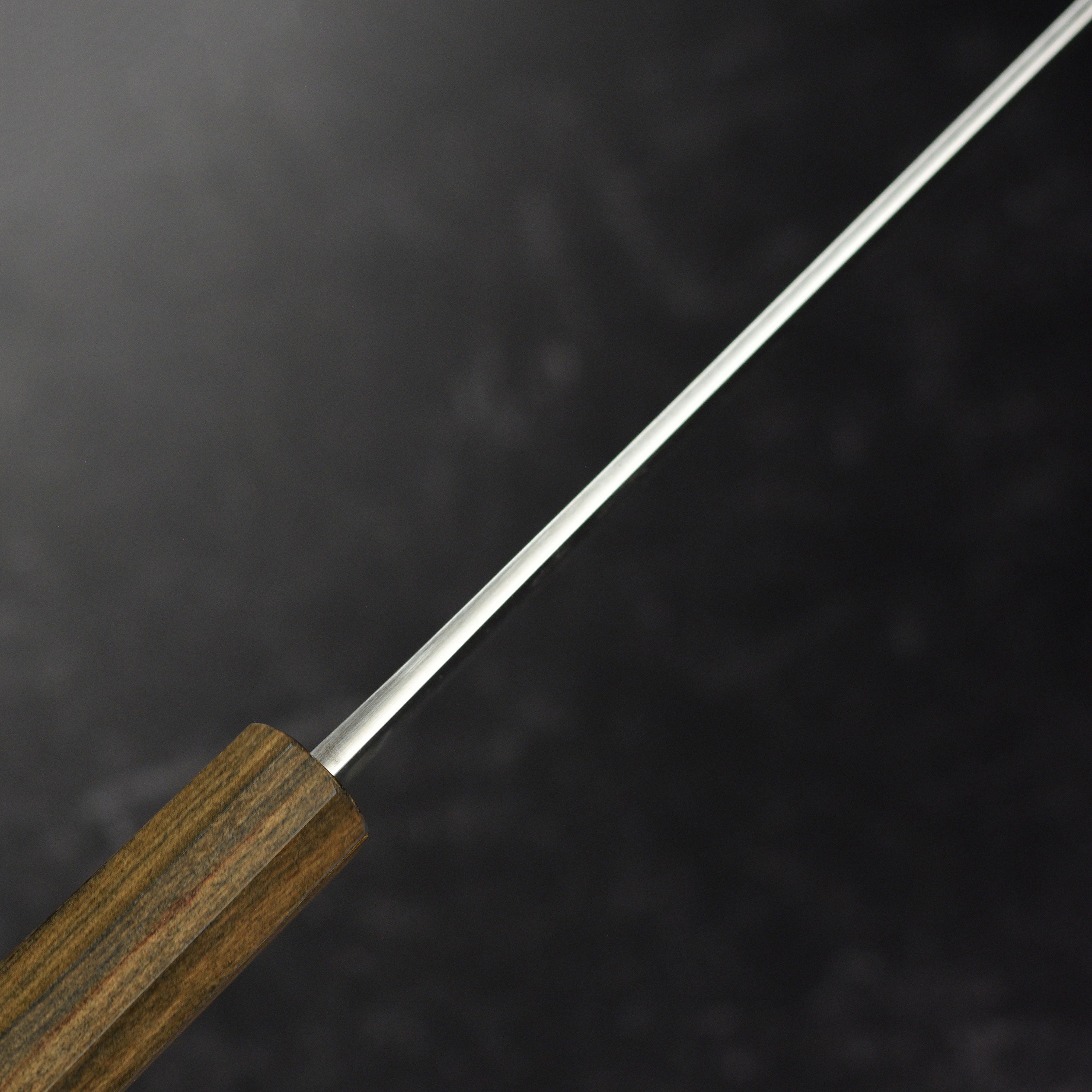 Yoshikane SKD Nashiji Gyuto Knife in action on a cutting board, demonstrating its effectiveness in slicing vegetables.