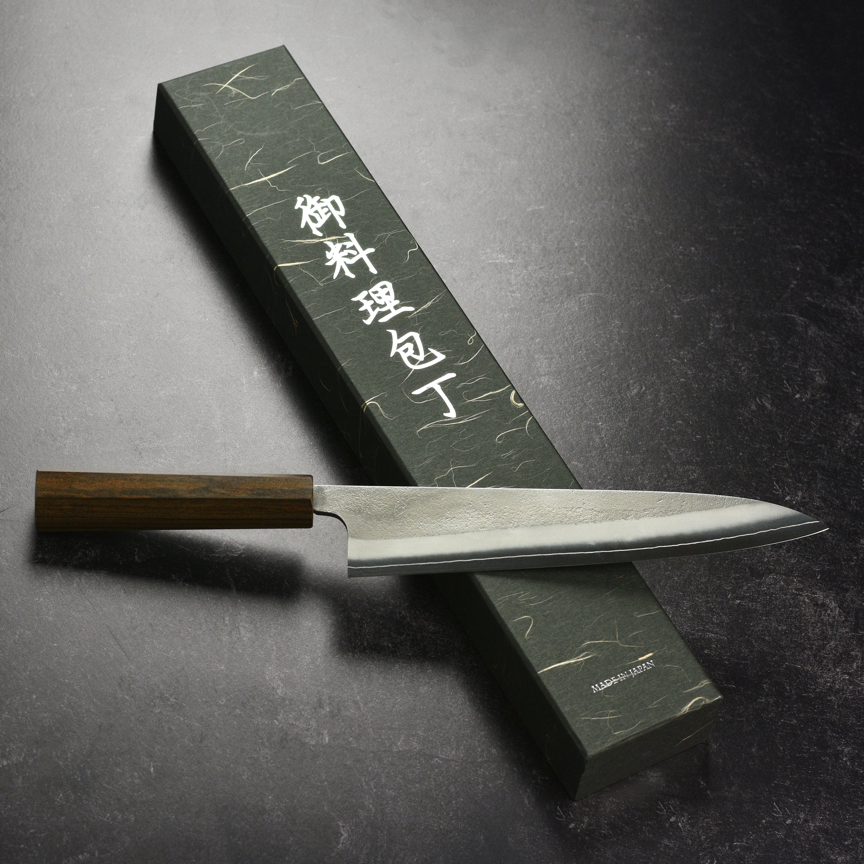 Yoshikane SKD Nashiji Gyuto Knife in action on a cutting board, demonstrating its effectiveness in slicing vegetables.
