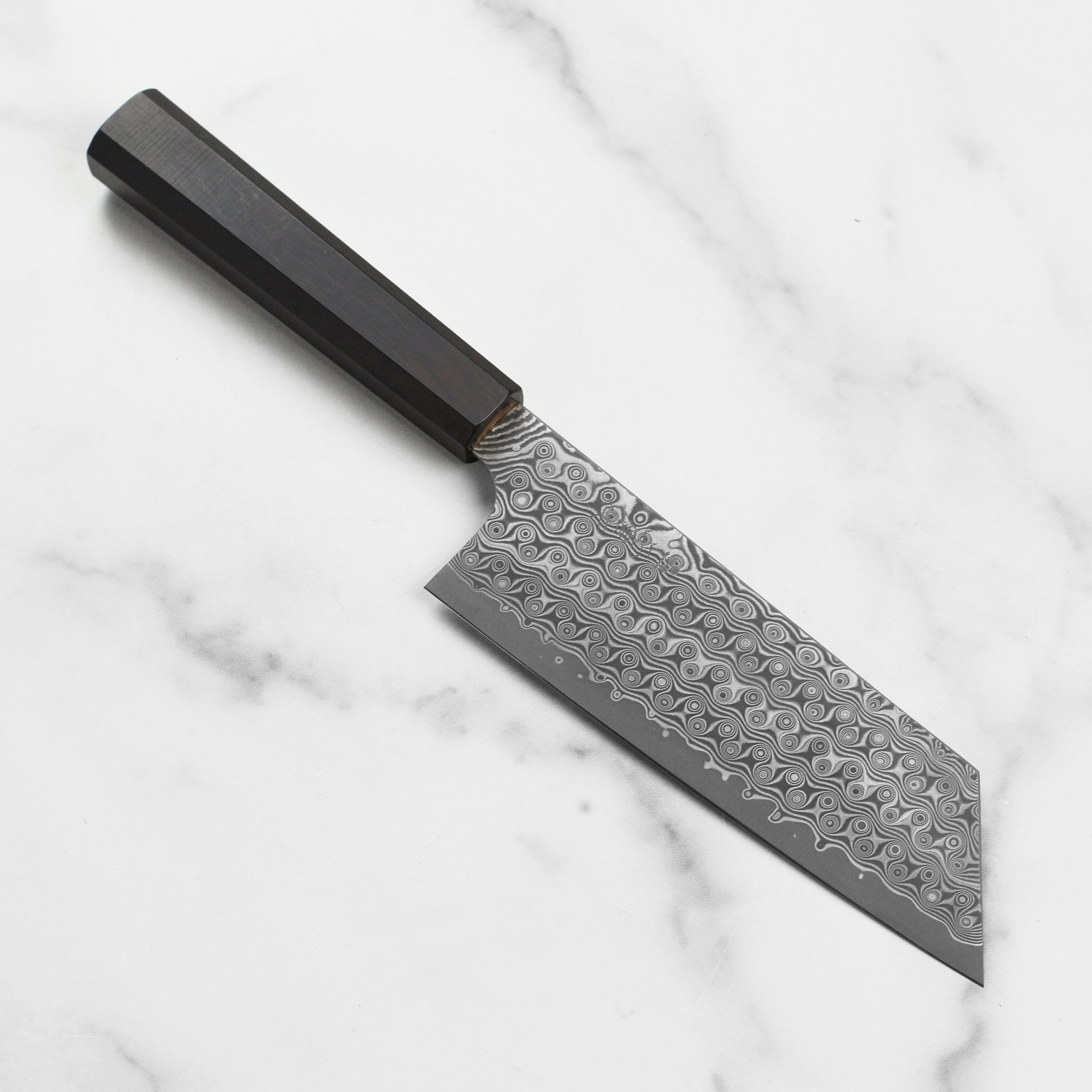 Nigara Anmon SG2 Damascus Kiritsuke Nakiri Knife with a close-up on the blade's intricate pattern.