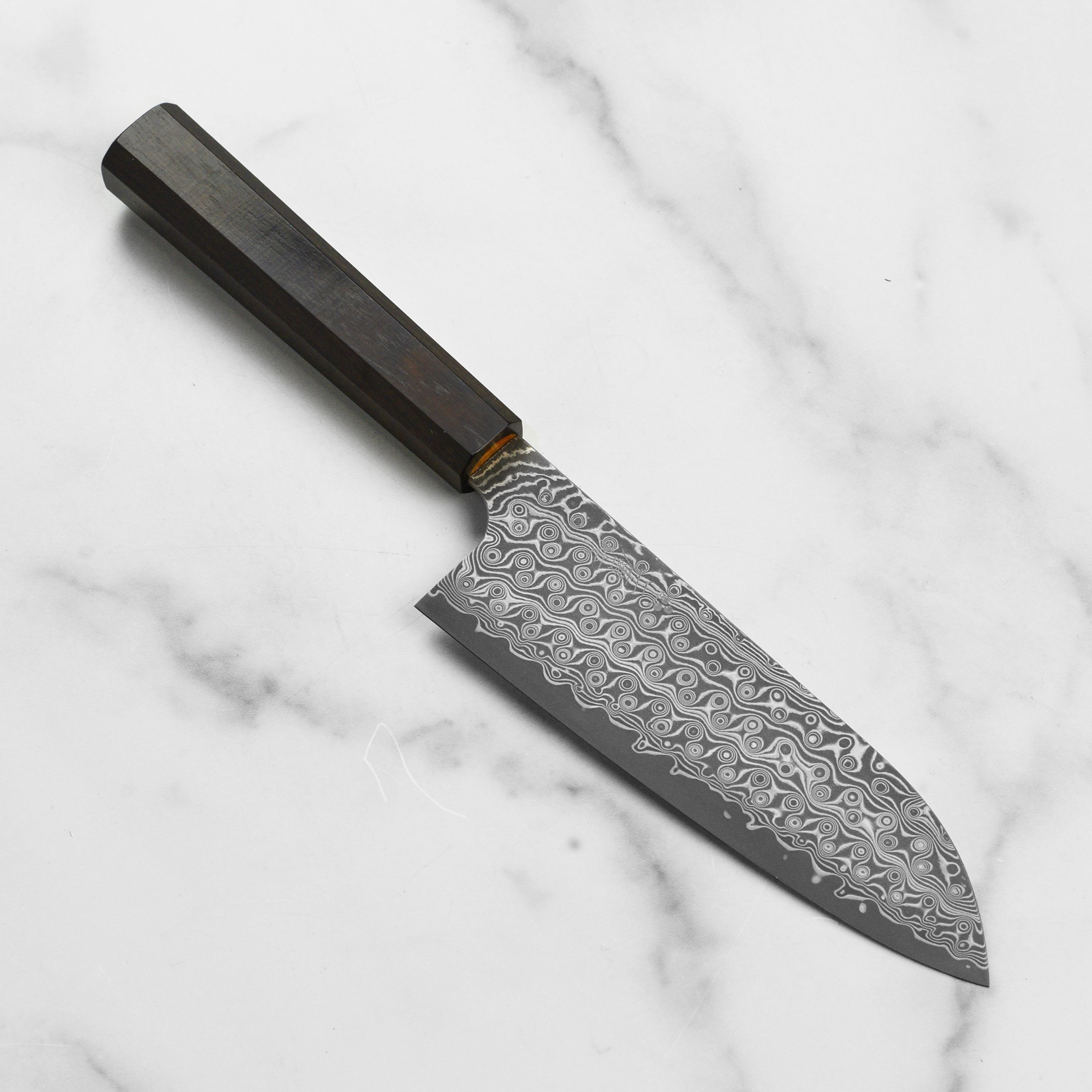 Close-up of Nigara Anmon SG2 Damascus 7-inch santoku knife blade showing intricate damascus pattern