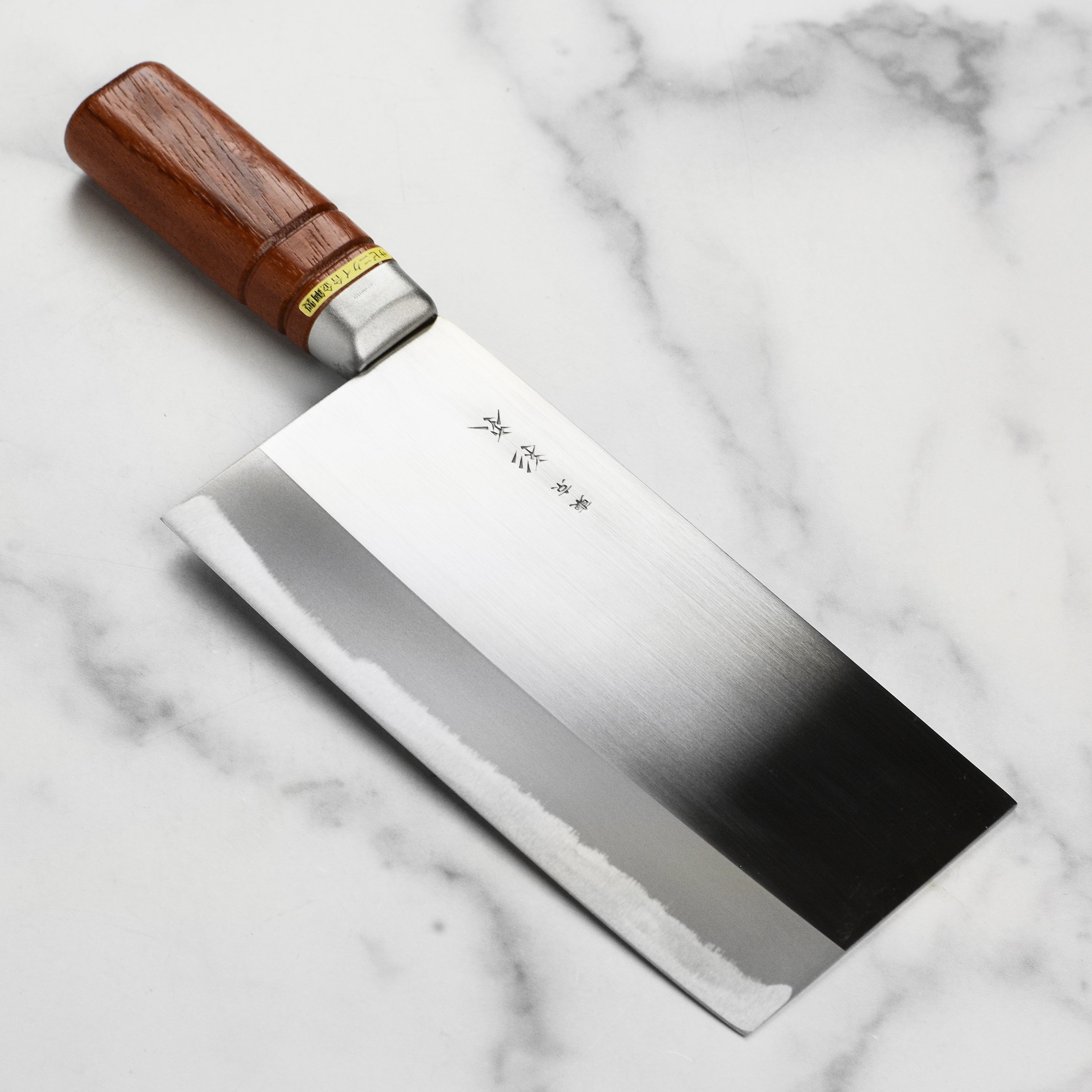 Sugimoto stainless steel Chinese cleaver on cutting board with vegetables