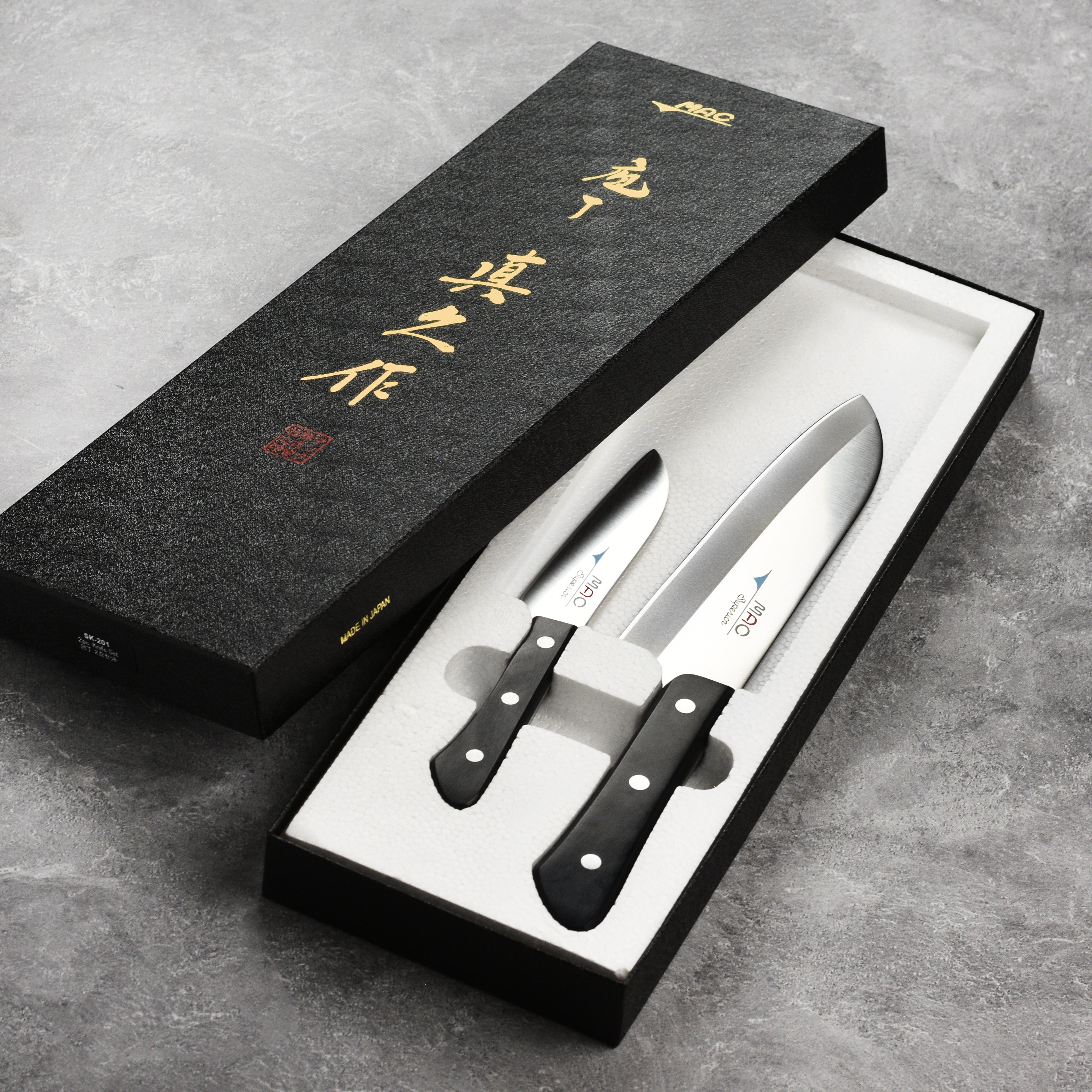 Elegant presentation of the MAC Superior knife set with a wooden cutting board.