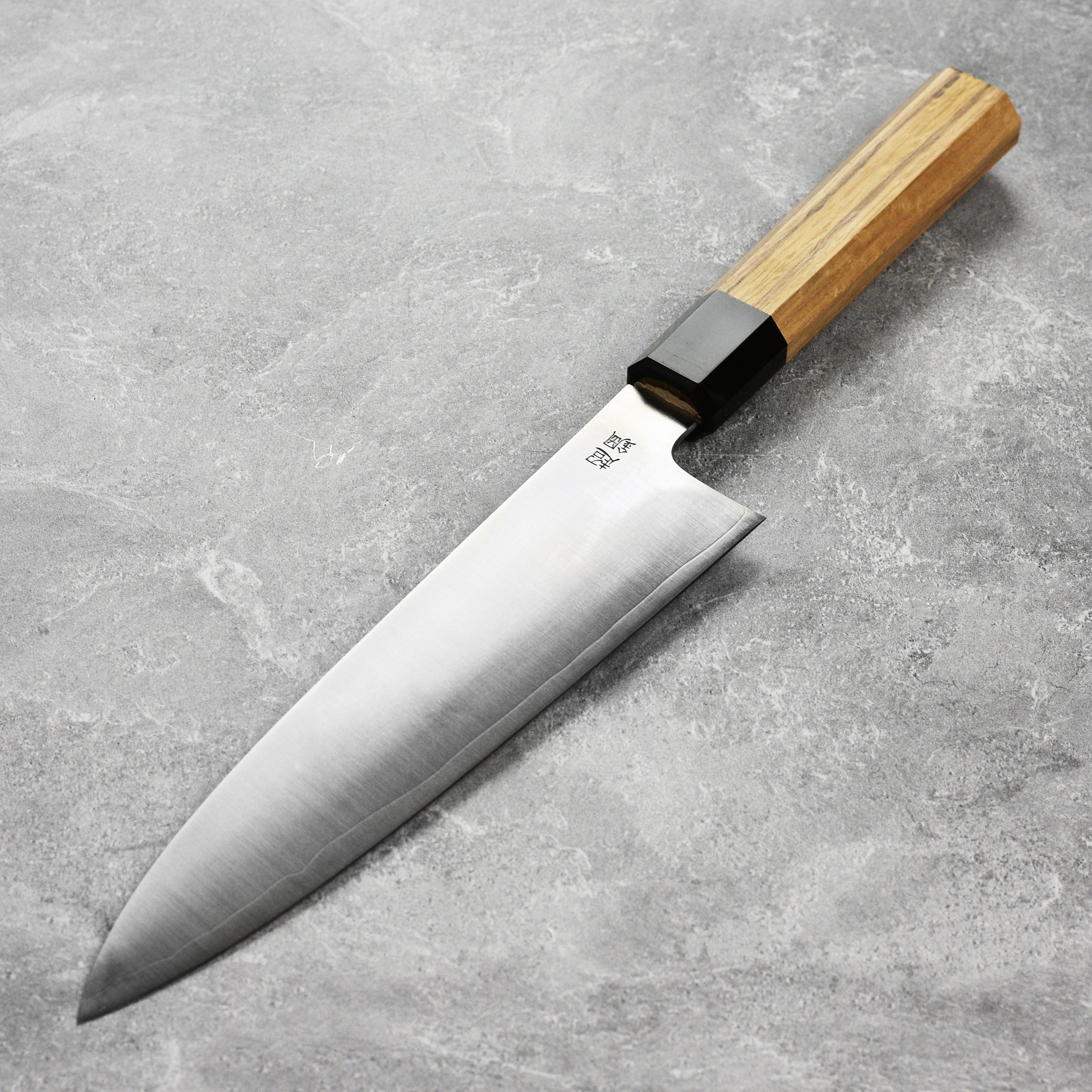 Close-up of the Sukenari ZDP189 blade highlighting its sharp edge and high-carbon steel finish.