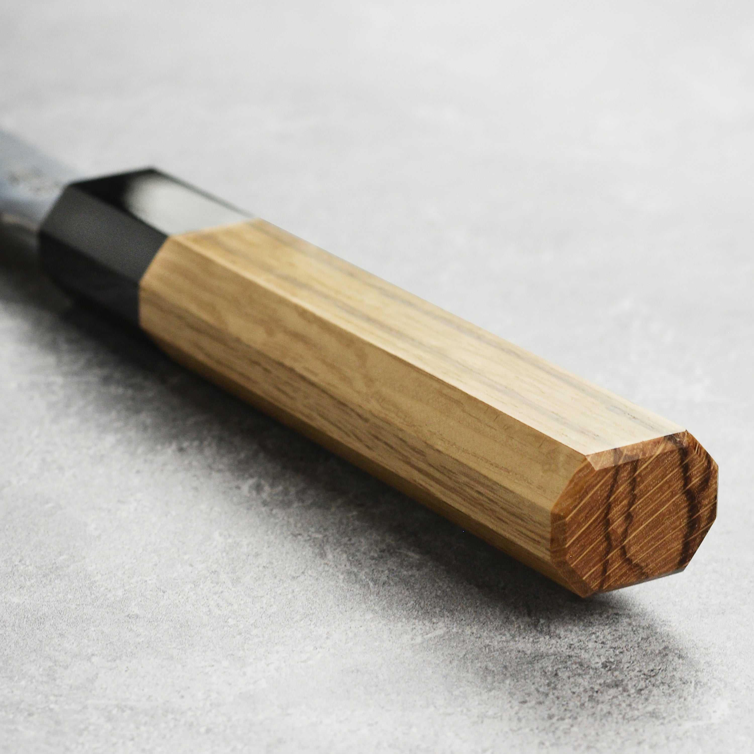 Close-up of the Sukenari ZDP189 blade highlighting its sharp edge and high-carbon steel finish.