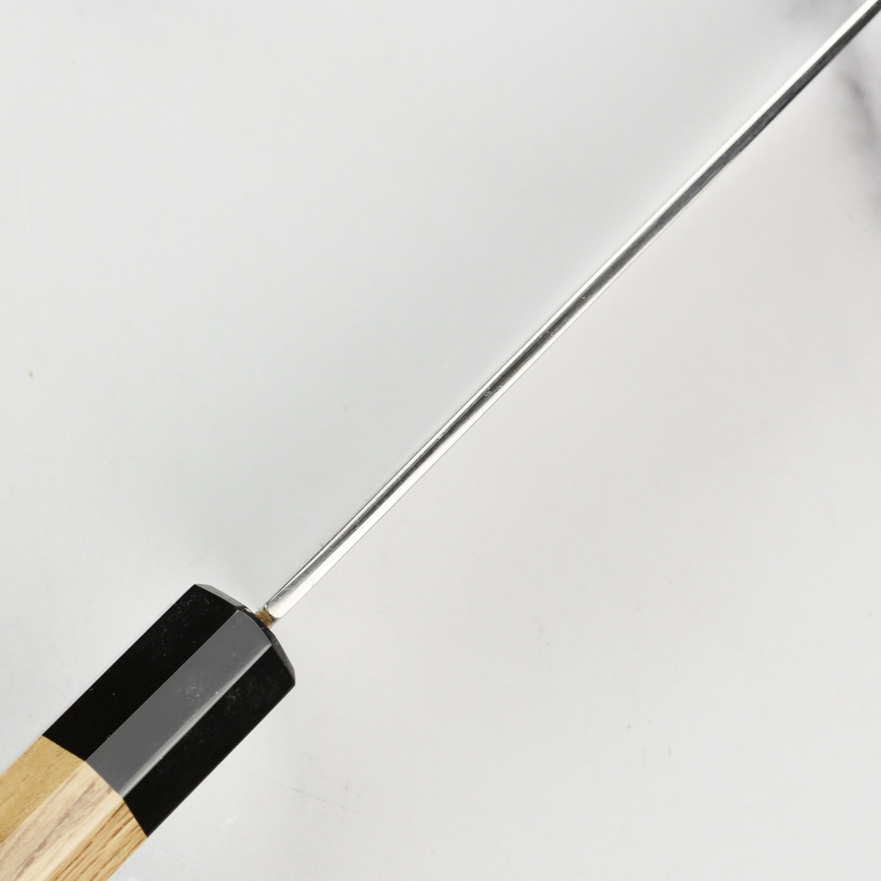 Close-up of the Sukenari ZDP189 Damascus knife highlighting its sharp edge and craftsmanship.