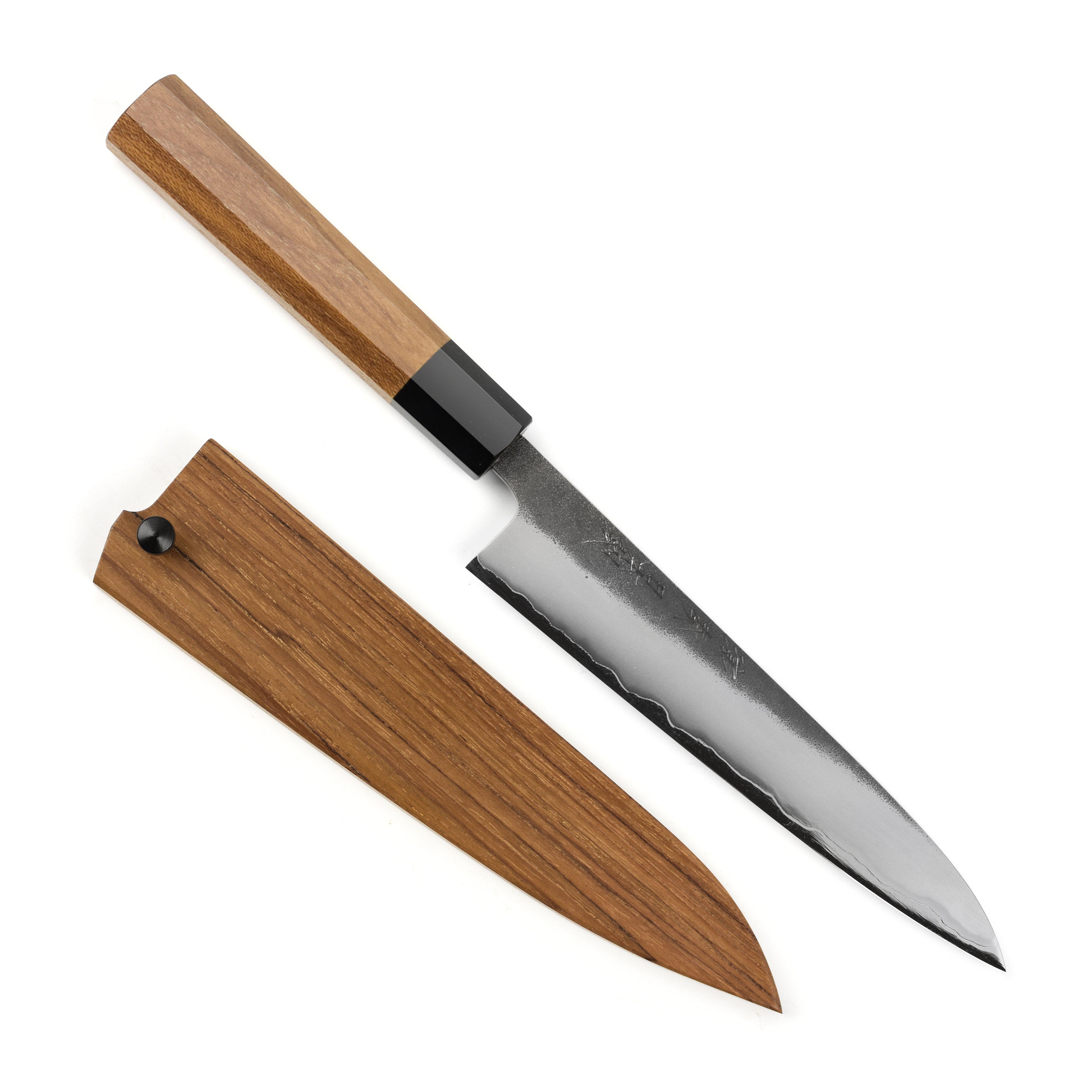 Teak wood handle of the Enso carbon steel petty knife highlighting its craftsmanship.