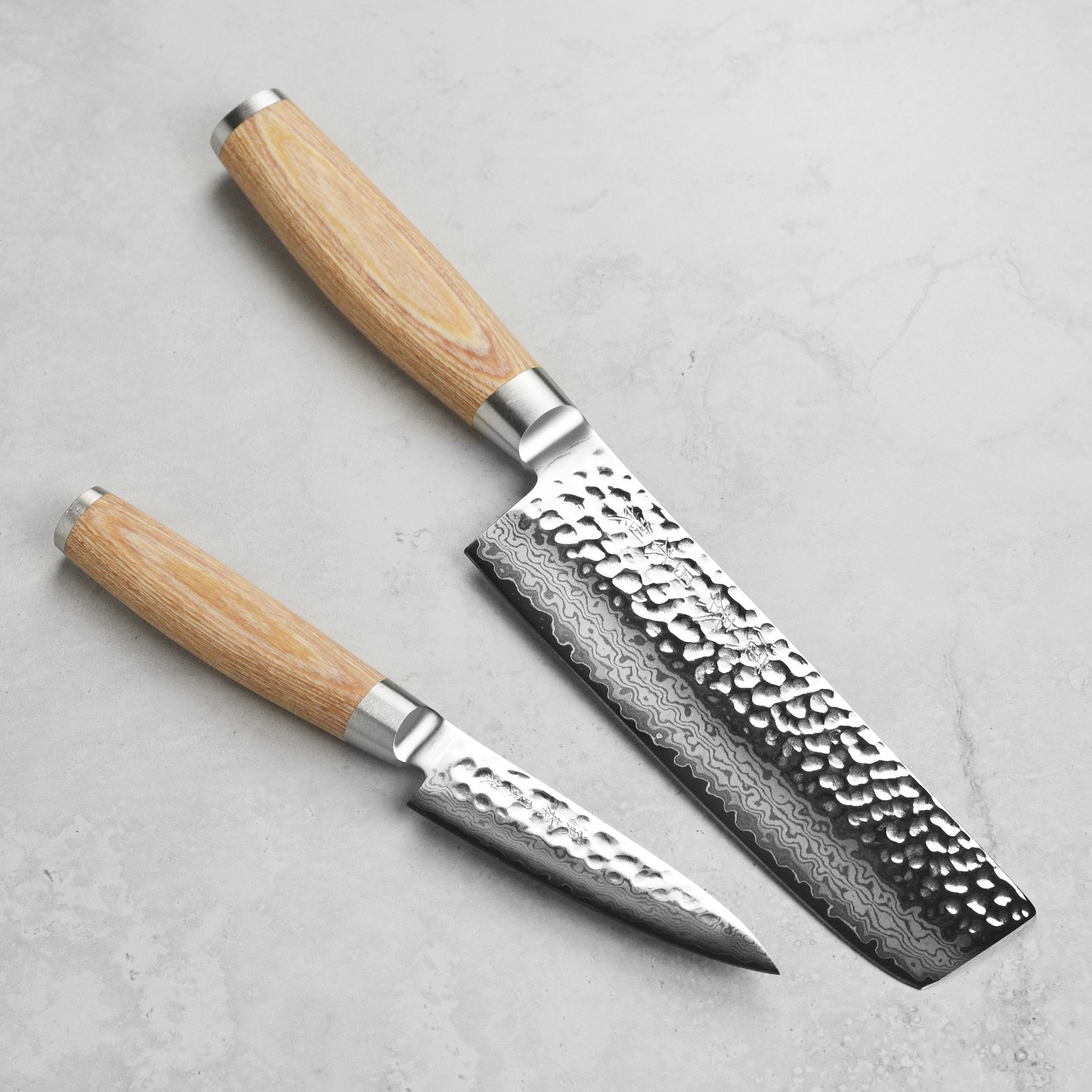 Close-up of the Enso Hizashi Nakiri knife highlighting the 37-layer Damascus blade and pakkawood handle, ideal for vegetable prep.