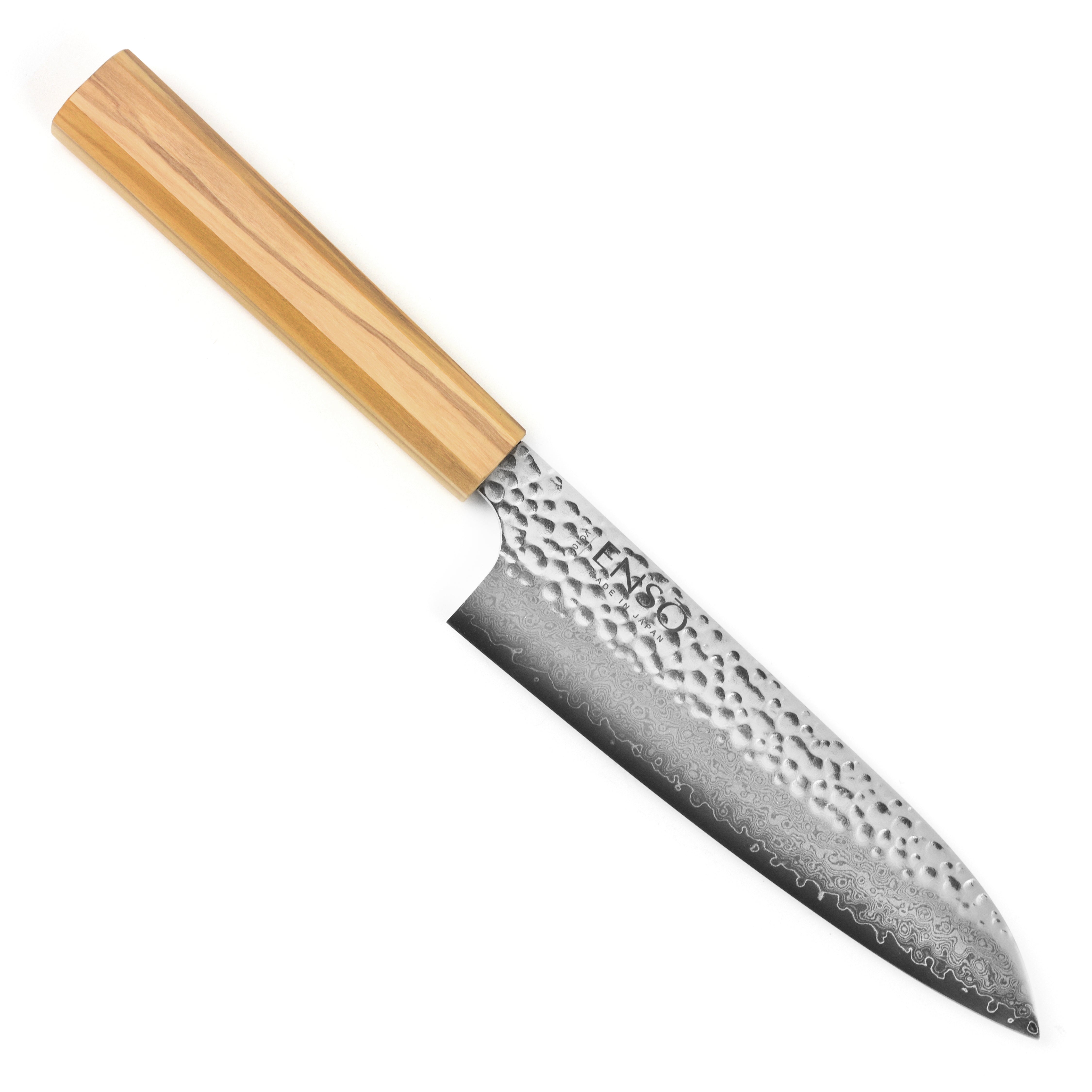 Enso Olivewood Santoku knife in action, slicing fresh vegetables on a cutting board.