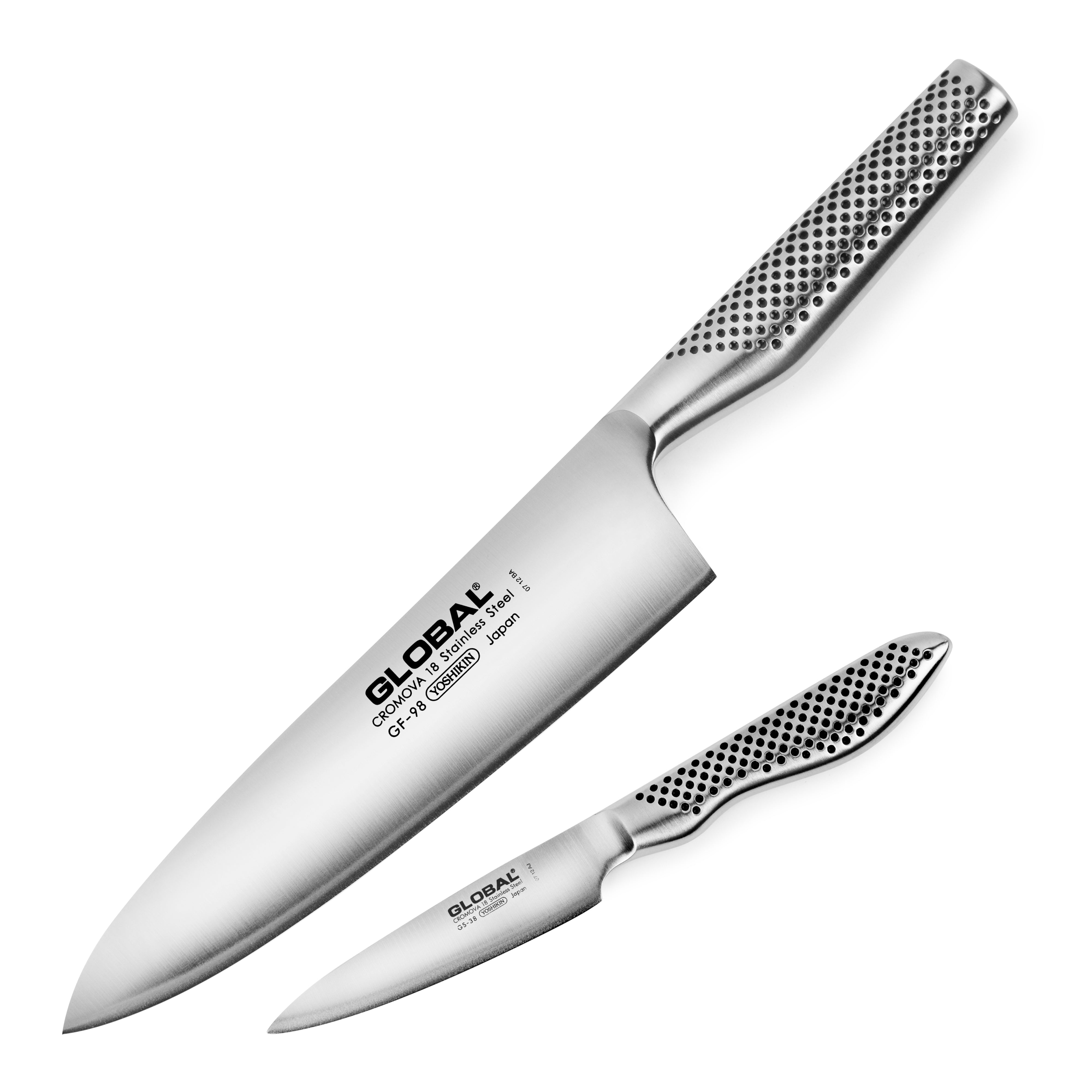 Set of Japanese kitchen knives including a chef knife and paring knife on a wooden cutting board