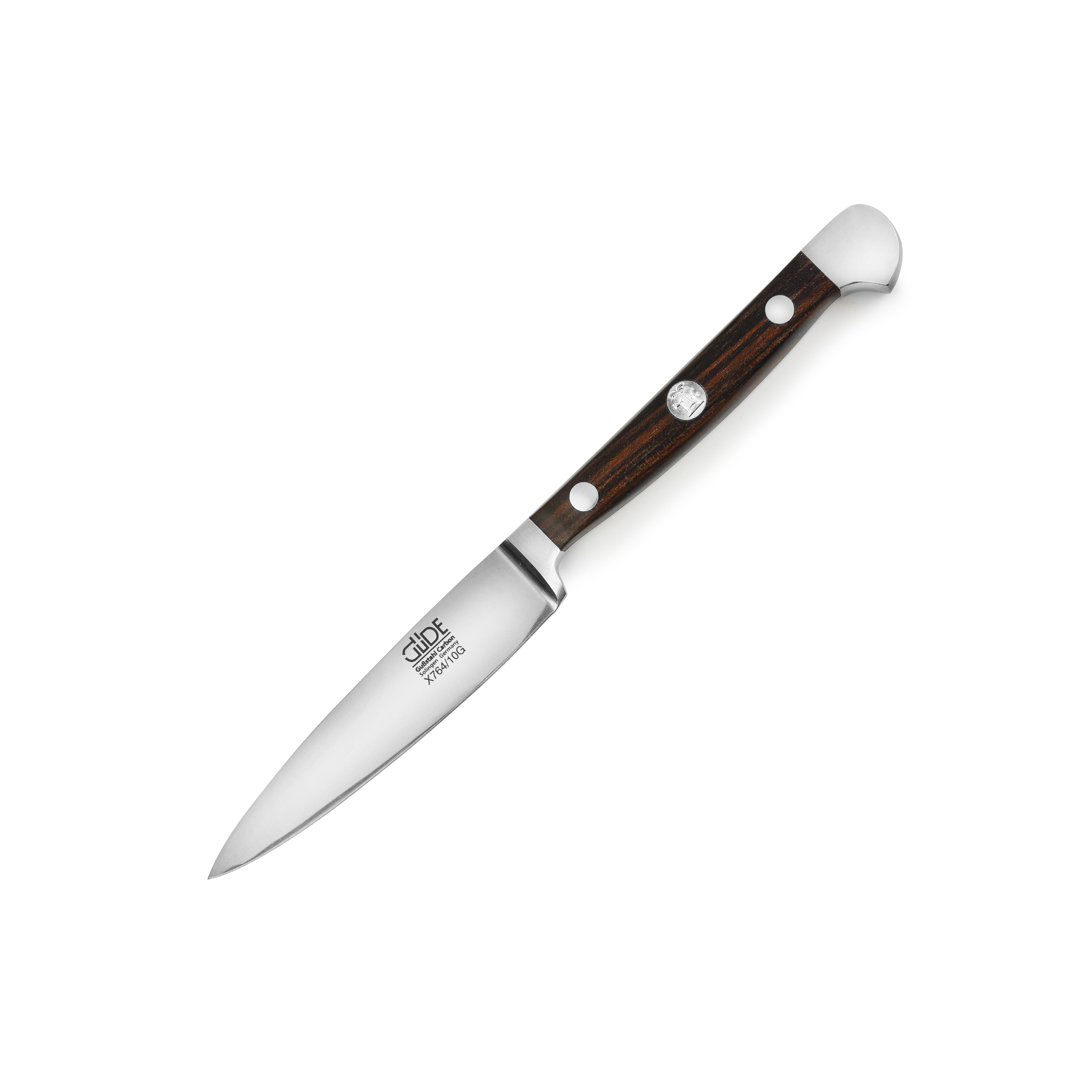 Gude Alpha 4" paring knife showcasing the handcrafted carbon steel blade and elegant ebony wood handle.