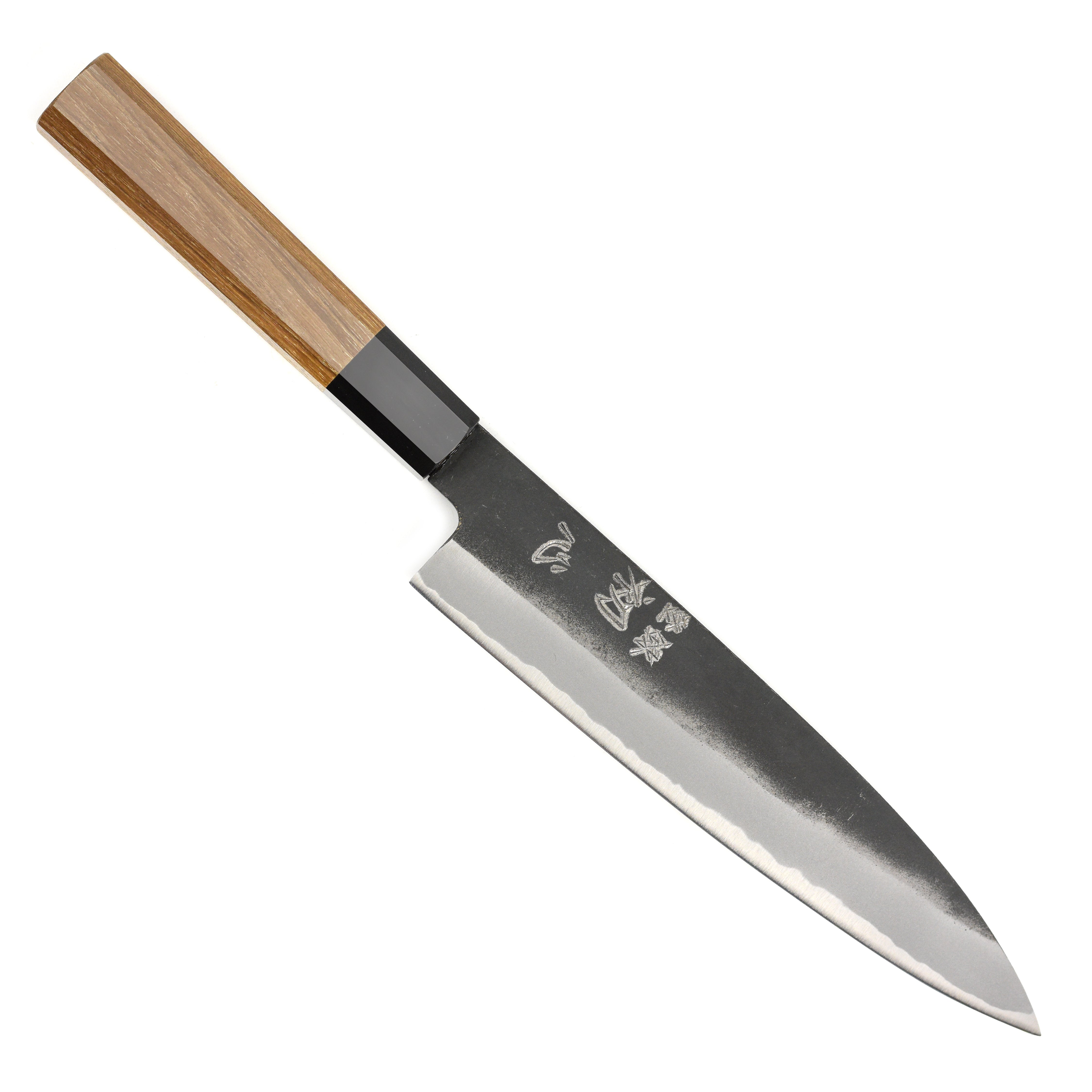 Close-up of the blade of the Aogami steel gyuto knife highlighting the kurouchi finish