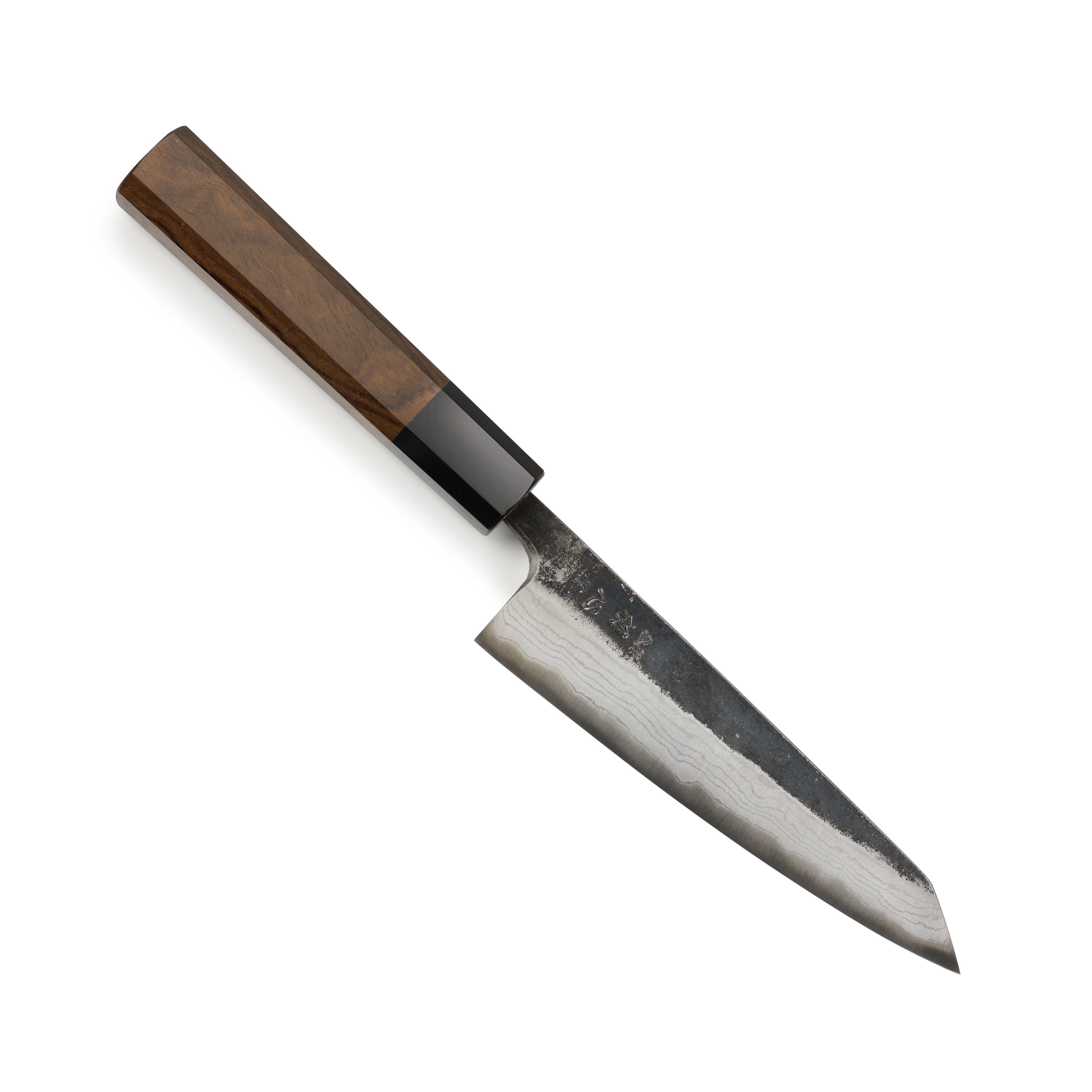 Close-up of the damascus steel blade with Kurouchi finish