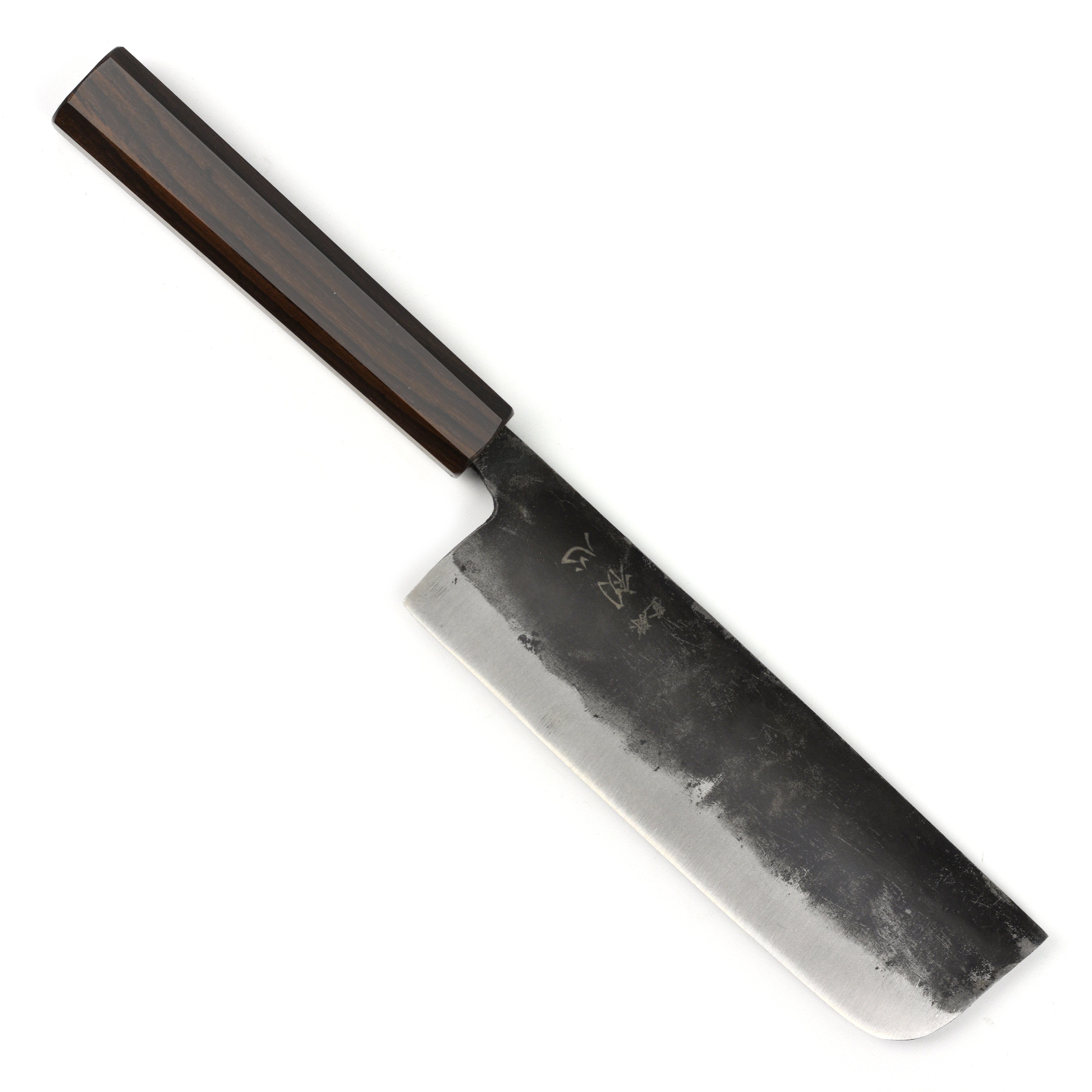 Chef using the Hatsukokoro Nakiri knife to chop fresh vegetables for a dish.