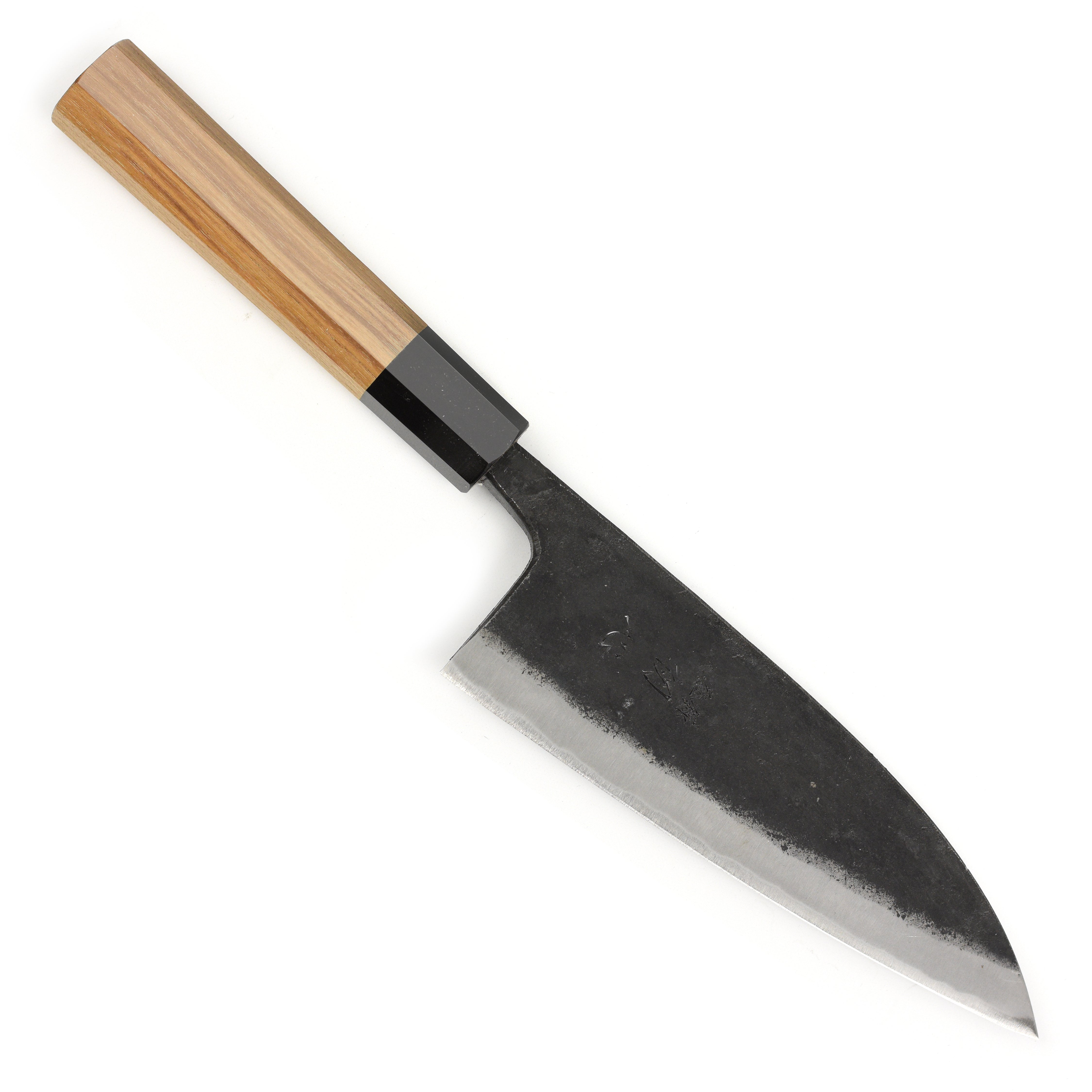 A detailed view of the 6.5-inch double bevel deba knife in a professional kitchen setting