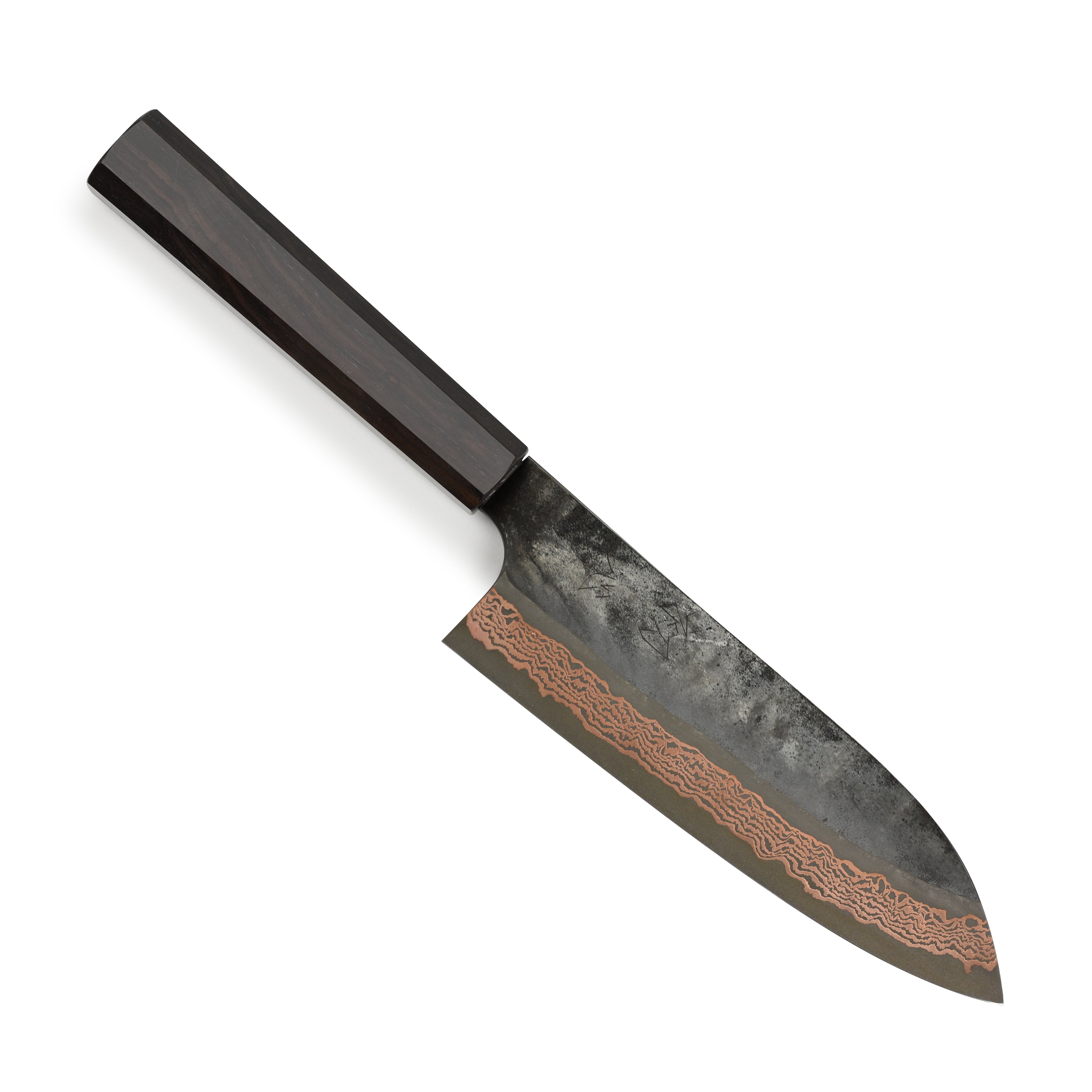 Close-up of the Hatsukokoro Santoku Knife on a wooden cutting board, highlighting its copper Damascus finish.