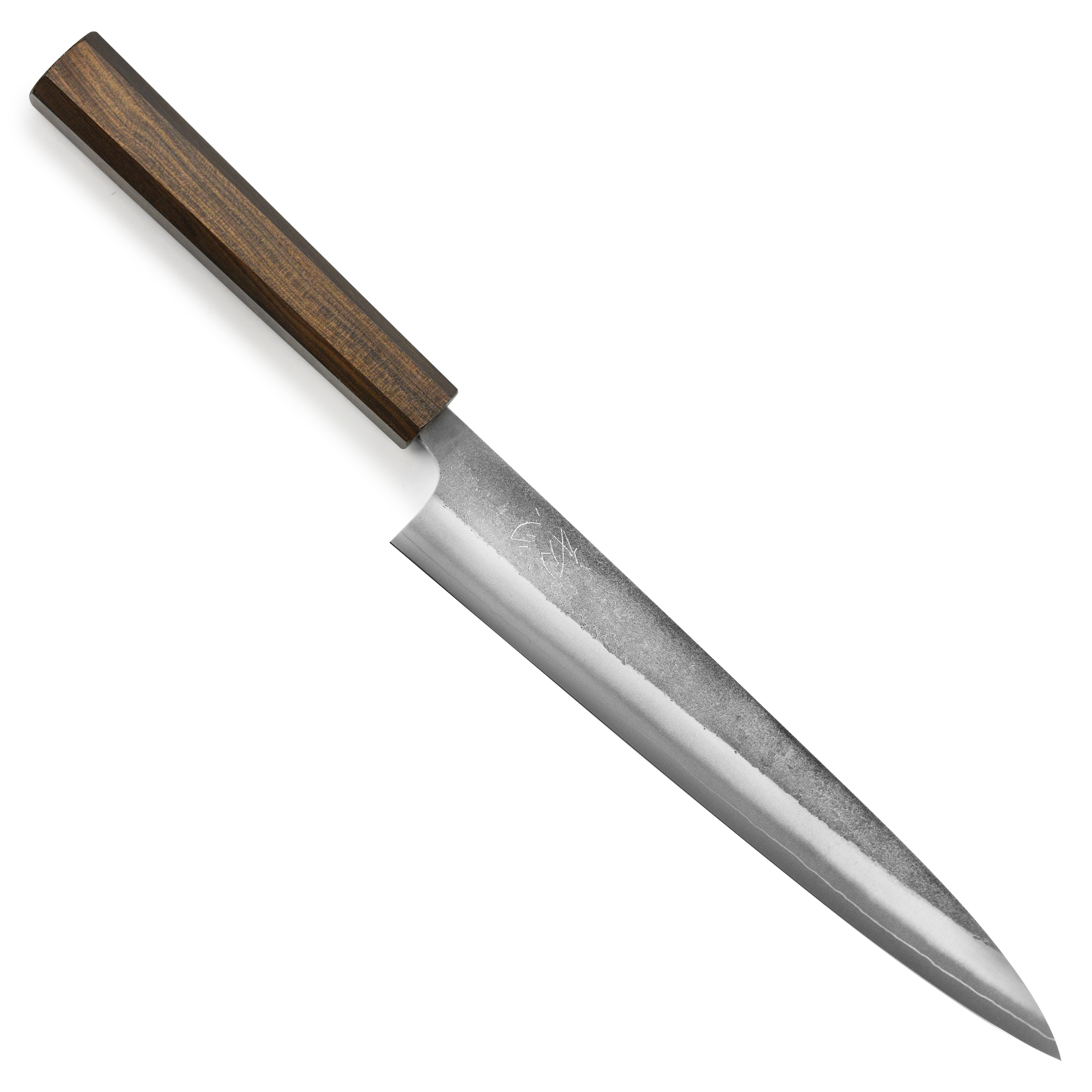 Yoshikane SKD Nashiji stainless clad sujihiki knife slicing fish on a cutting board