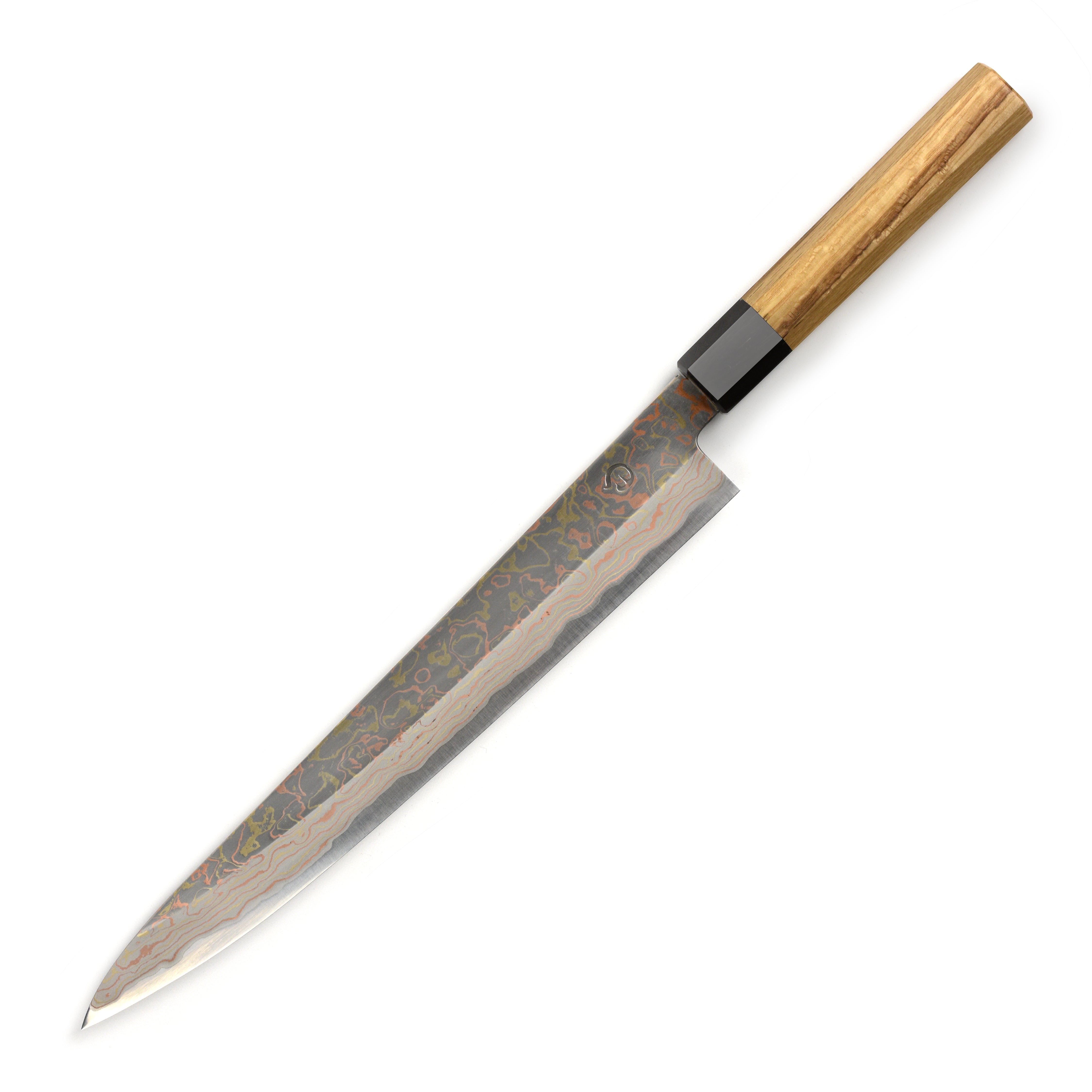 Japanese chef slicing fish with a Damascus sujihiki knife in a professional kitchen