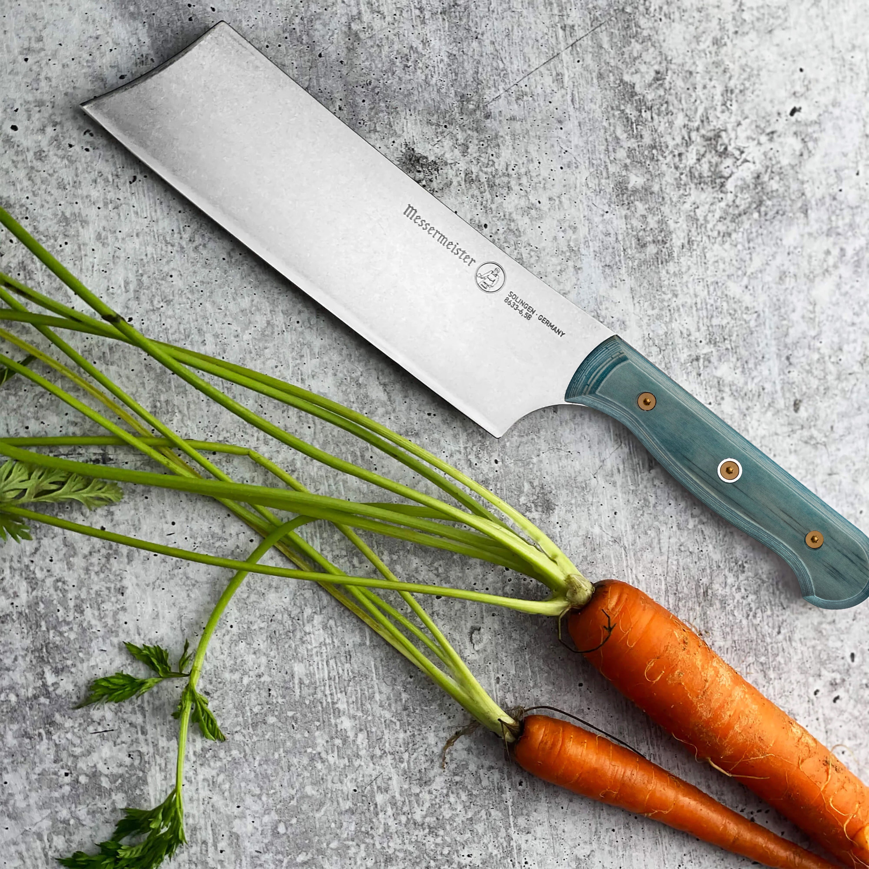 Messermeister Nakiri knife showing the blades ceramic stonewash finish and ergonomic handle.