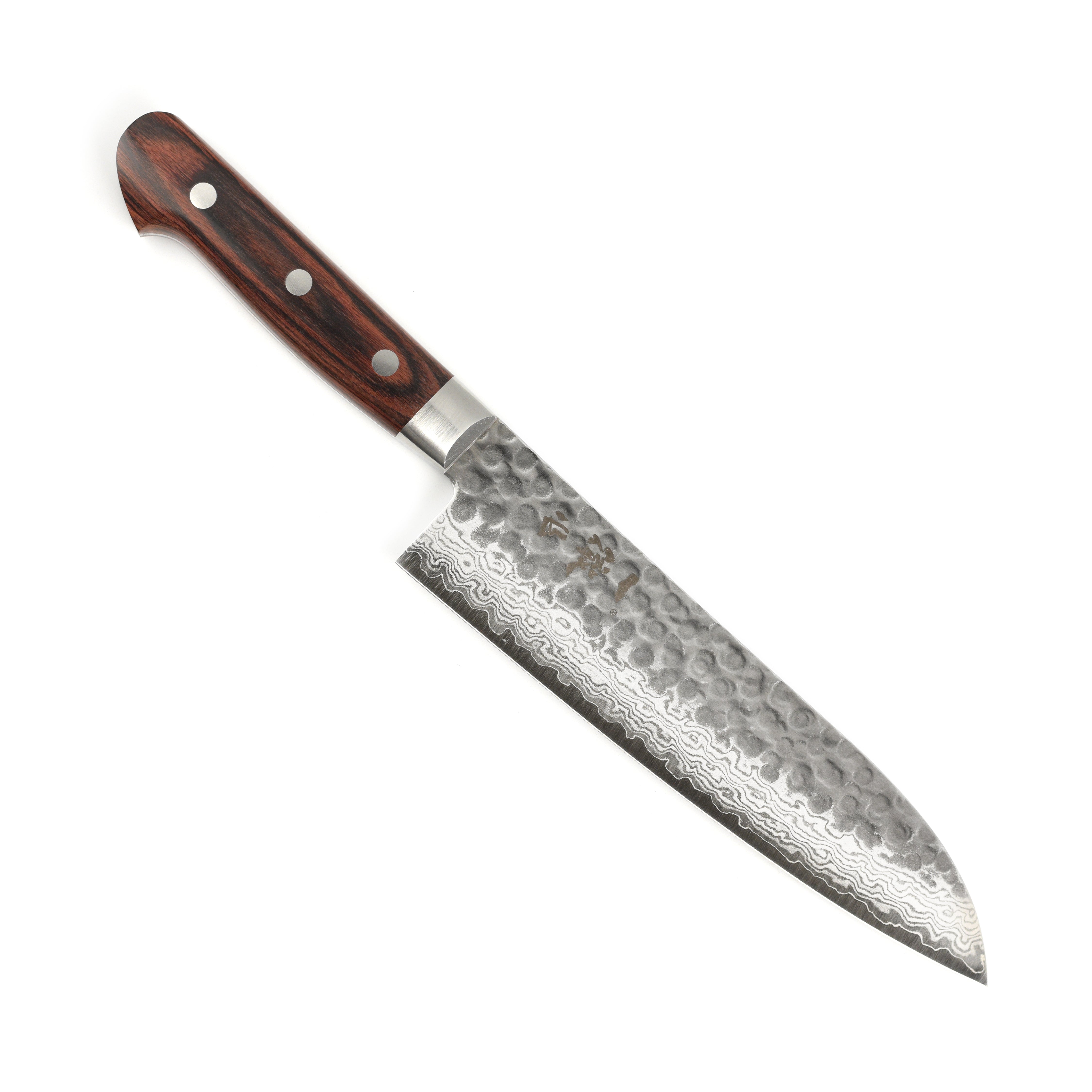 Close-up of the Ittetsu VG10 Santoku Knife in action, slicing fresh vegetables with precision.