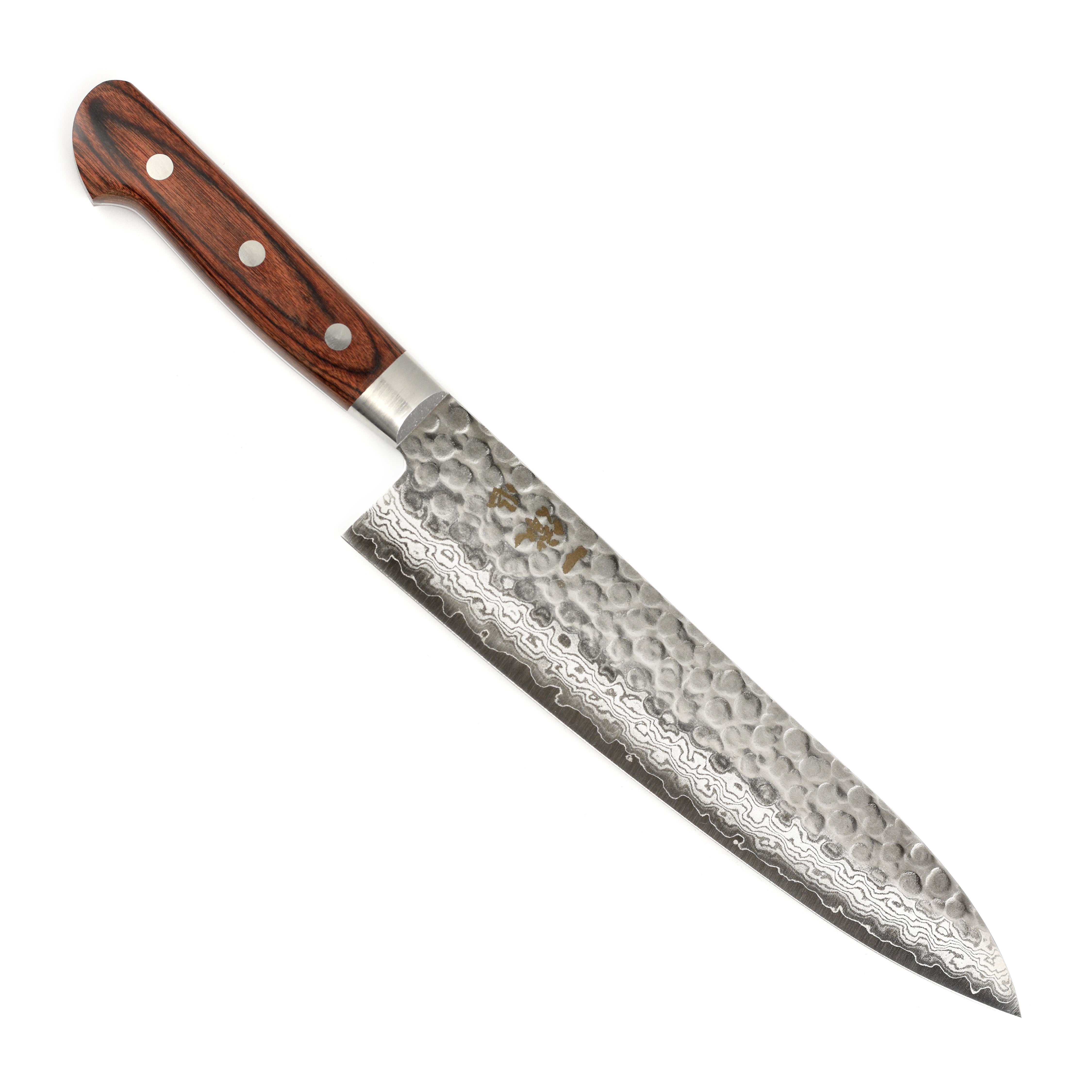 Professional chef using the Ittetsu gyuto knife for precision slicing in a modern kitchen.