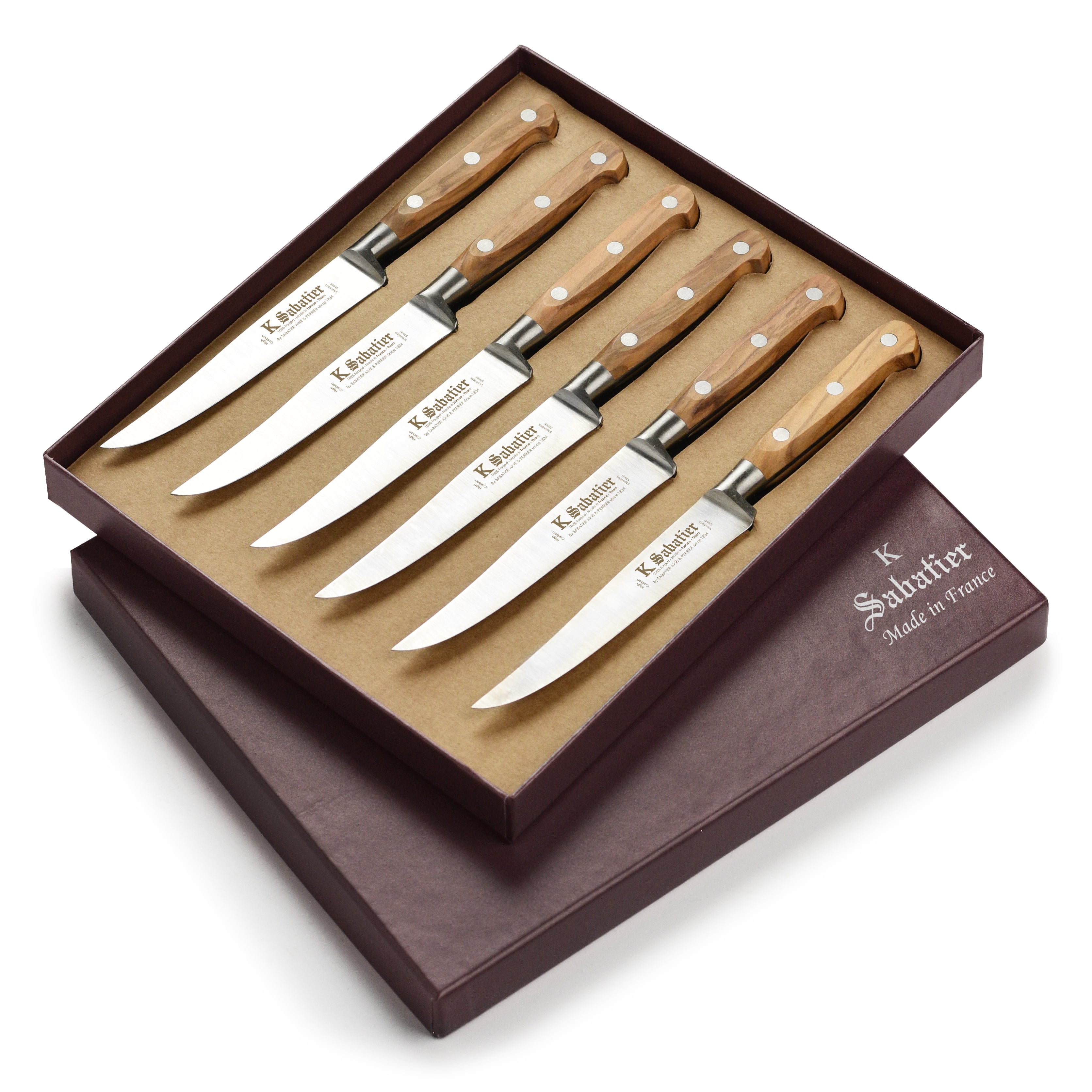 Close-up of olive wood steak knives with stainless steel rivets for elegant kitchen cutlery
