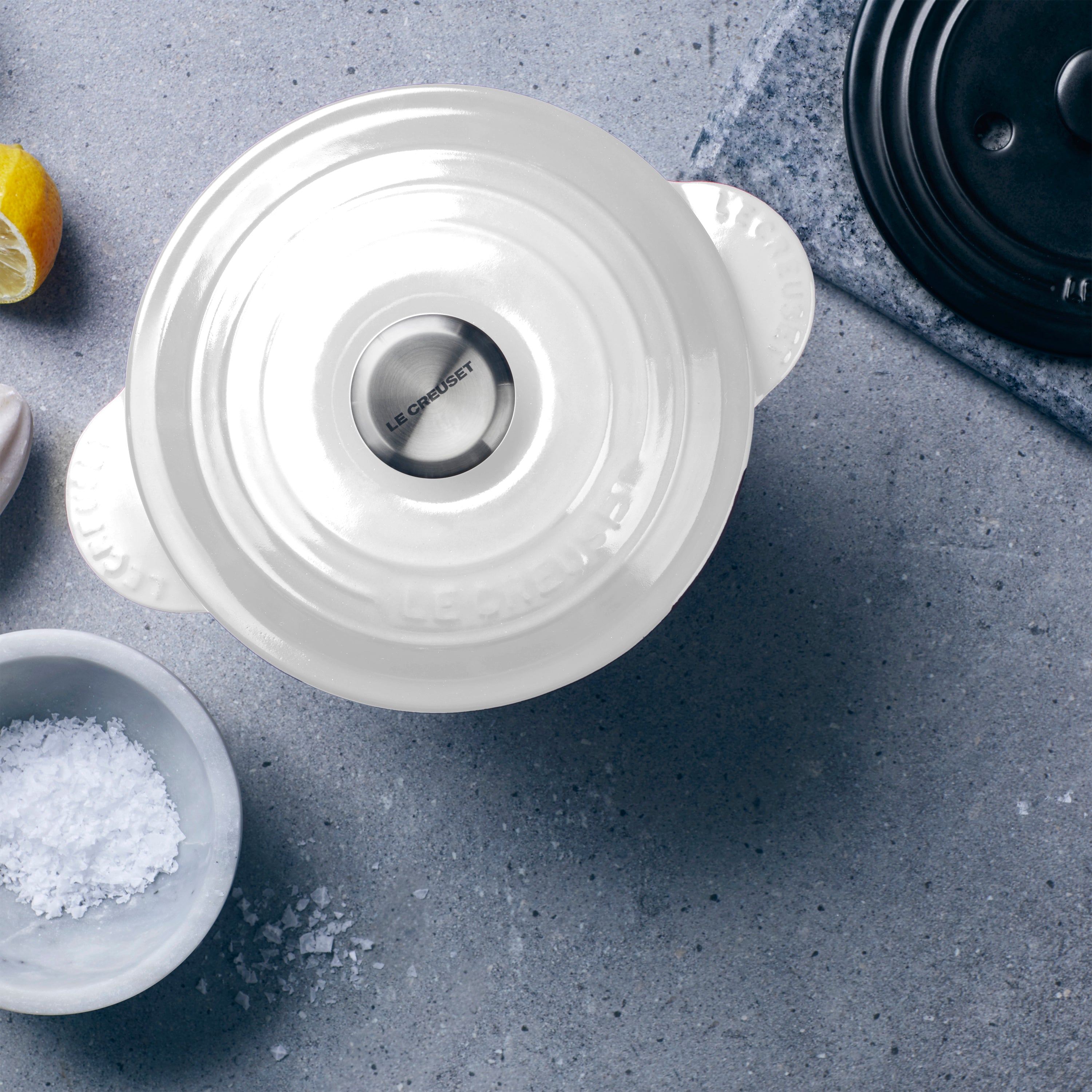 Le Creuset rice pot in action on a kitchen stove, demonstrating its compatibility with various cooktops.