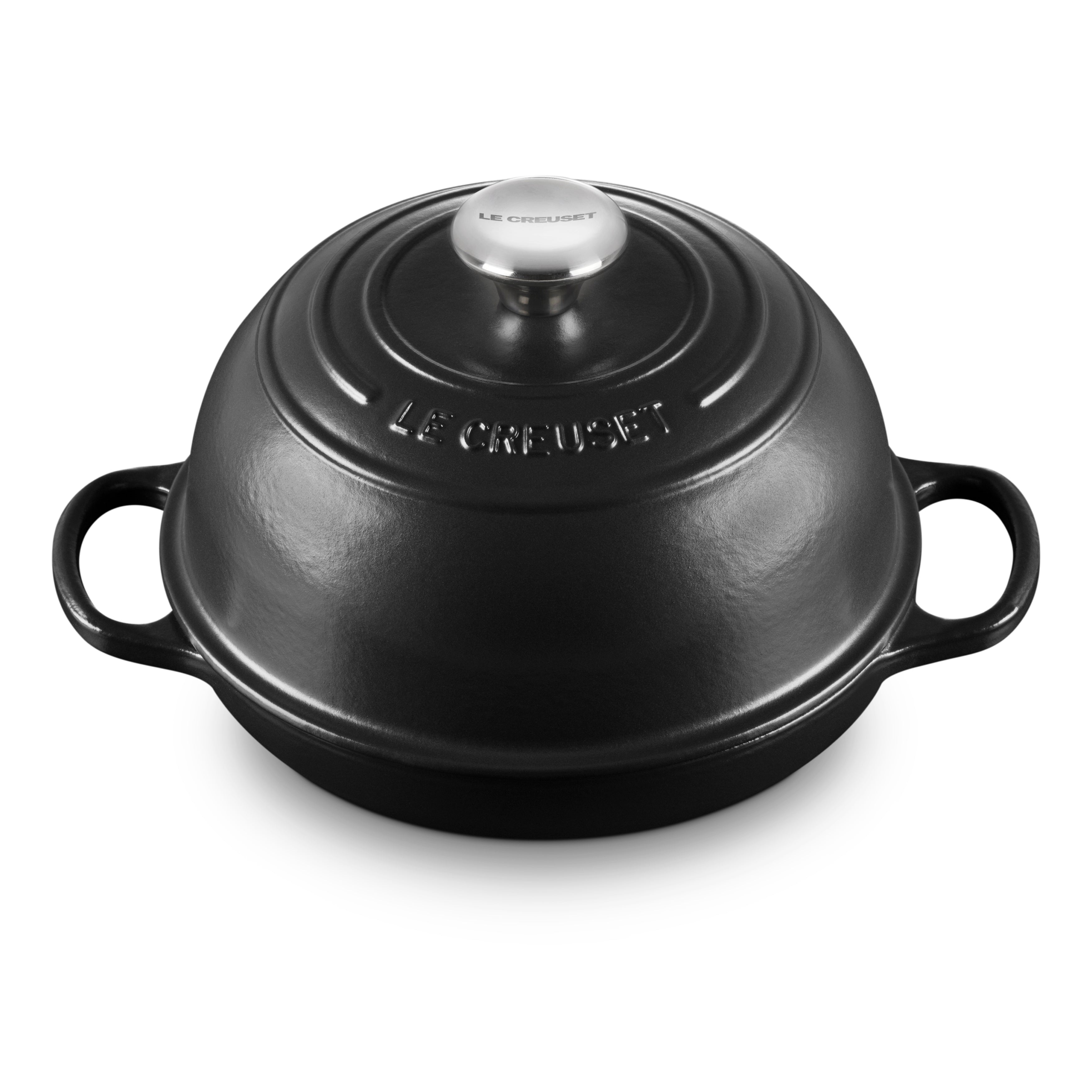 Close-up of Le Creuset cast iron bread oven with lid on, highlighting its enamel coating and ergonomic handles