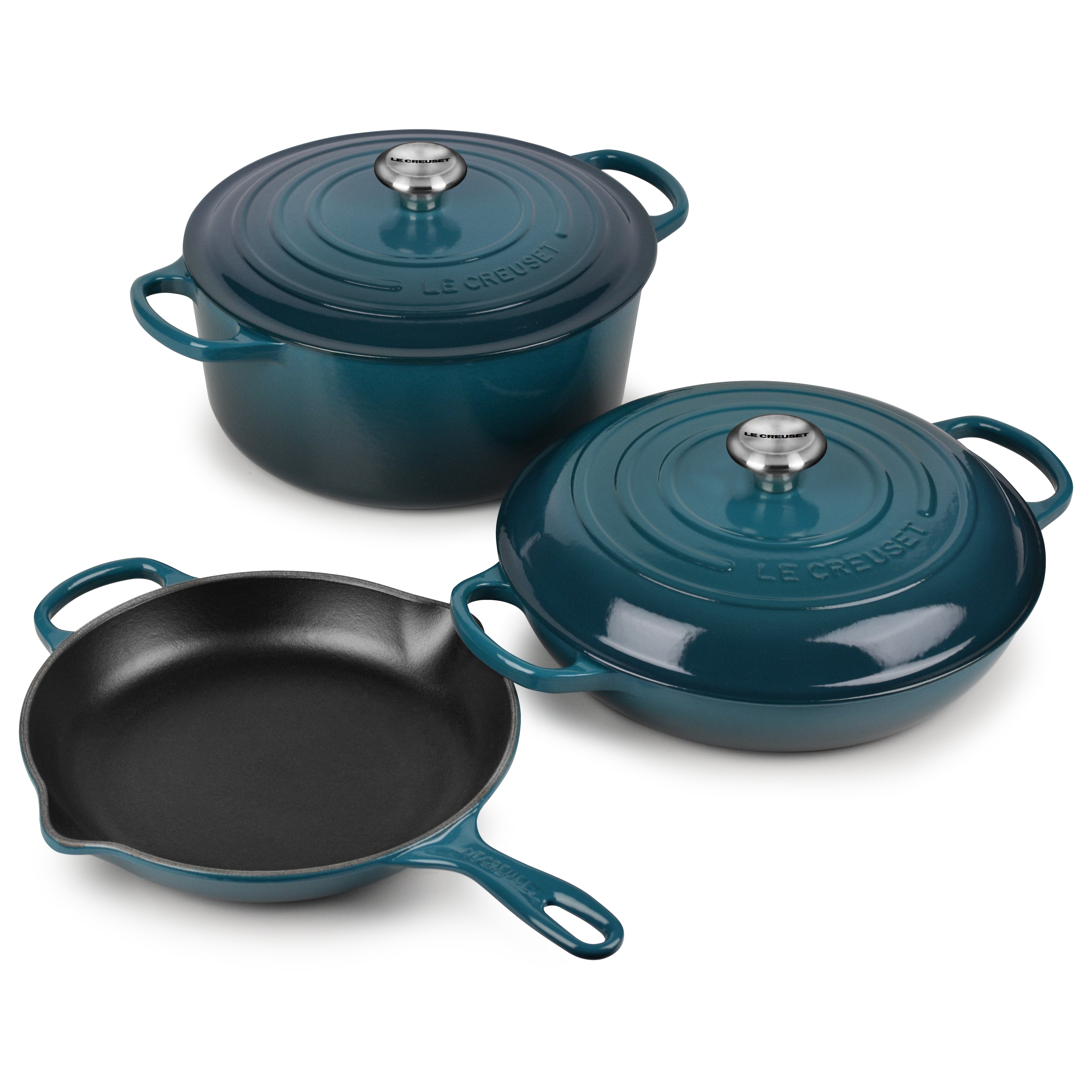 Top view of Le Creuset Deep Teal cast iron cookware set arranged on an induction cooktop