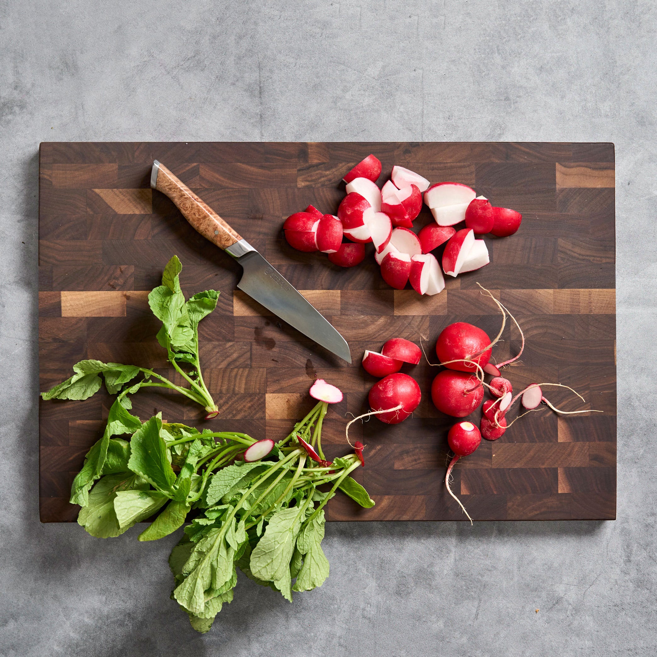 Side view of Steelport end-grain walnut cutting board highlighting beveled edges and slim profile