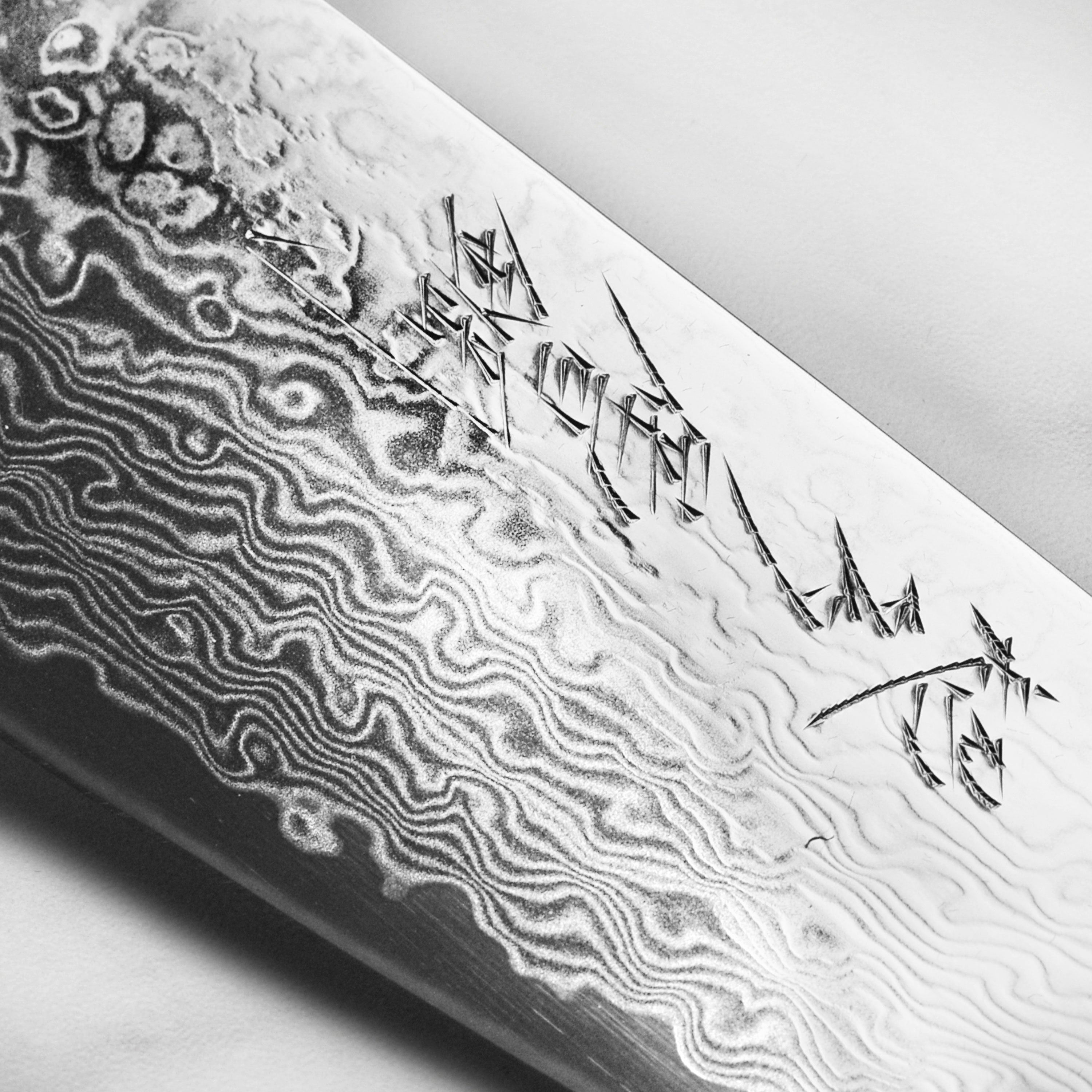 Handcrafted Japanese Damascus kitchen knife on a wooden cutting board