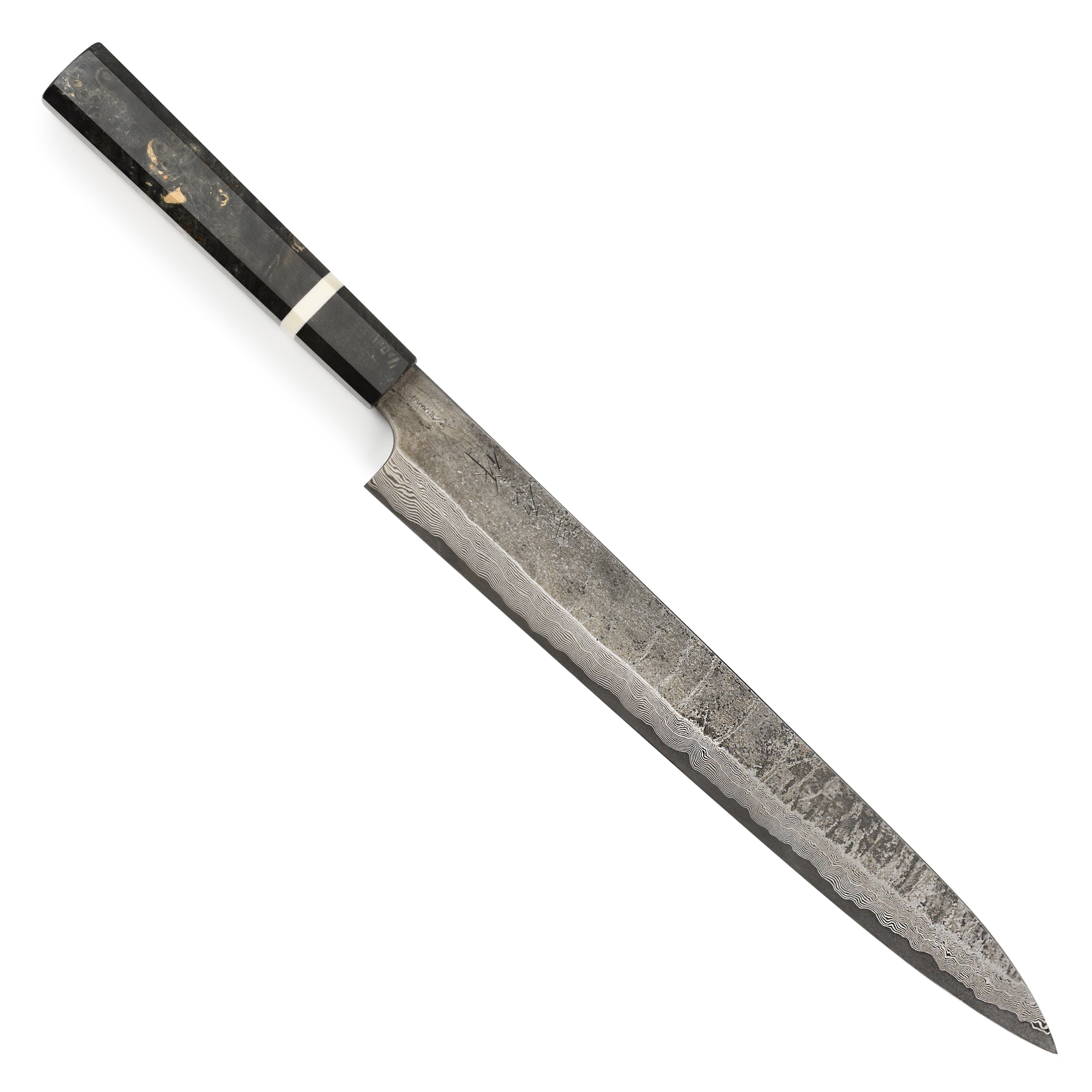 Chef using the Nigara Ginsan Damascus Sujihiki Knife to slice fish with precision.