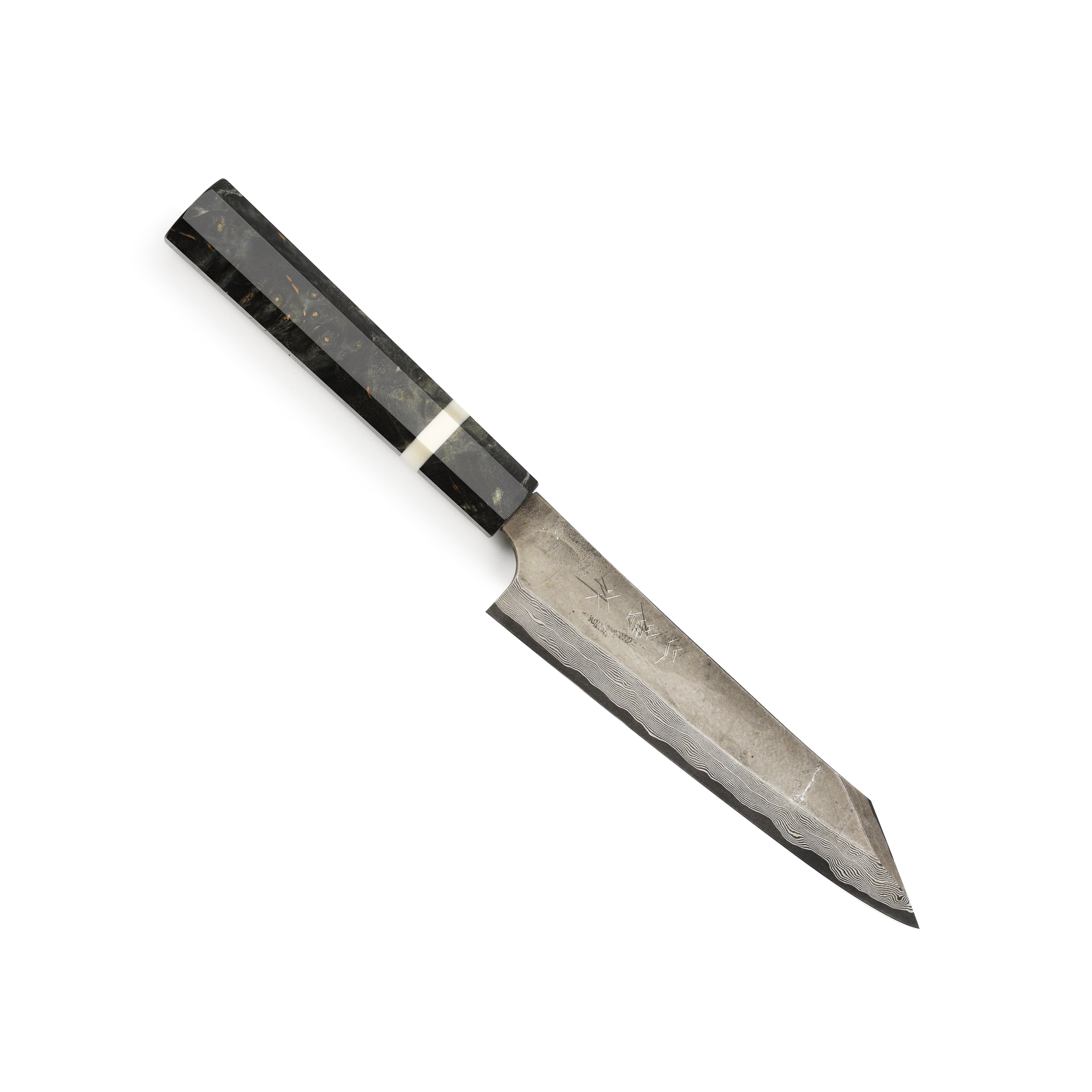Professional chef using a damascus kiritsuke knife for vegetable prep